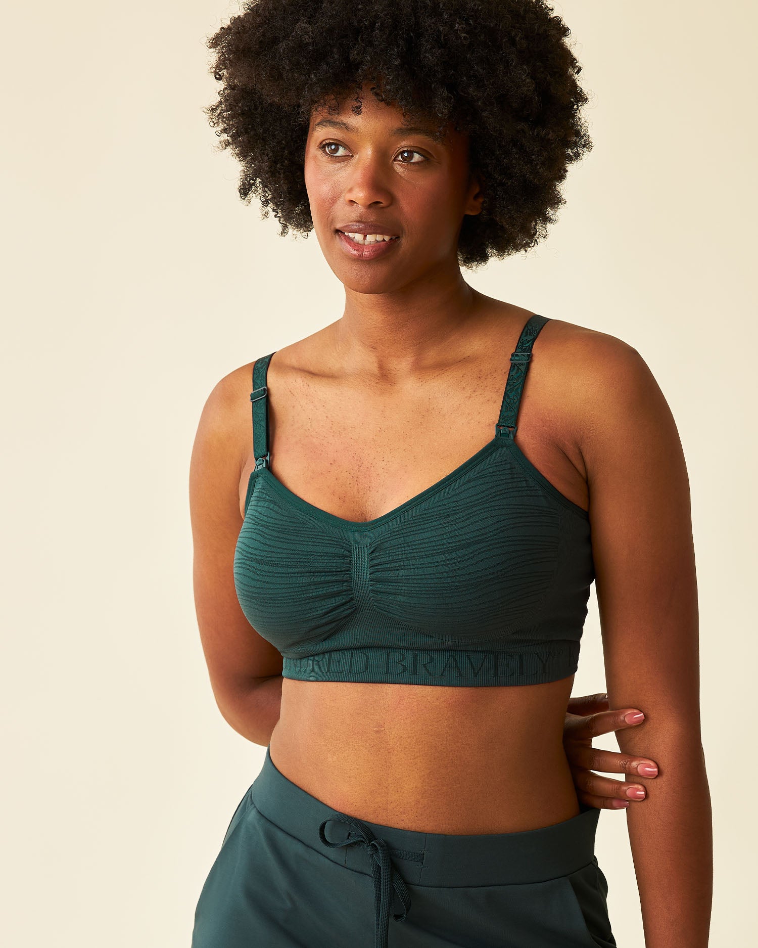 Front view of model wearing Sublime® Hands-Free Pumping & Nursing Bra in Evergreen @model_info:Kyra is wearing a Small.