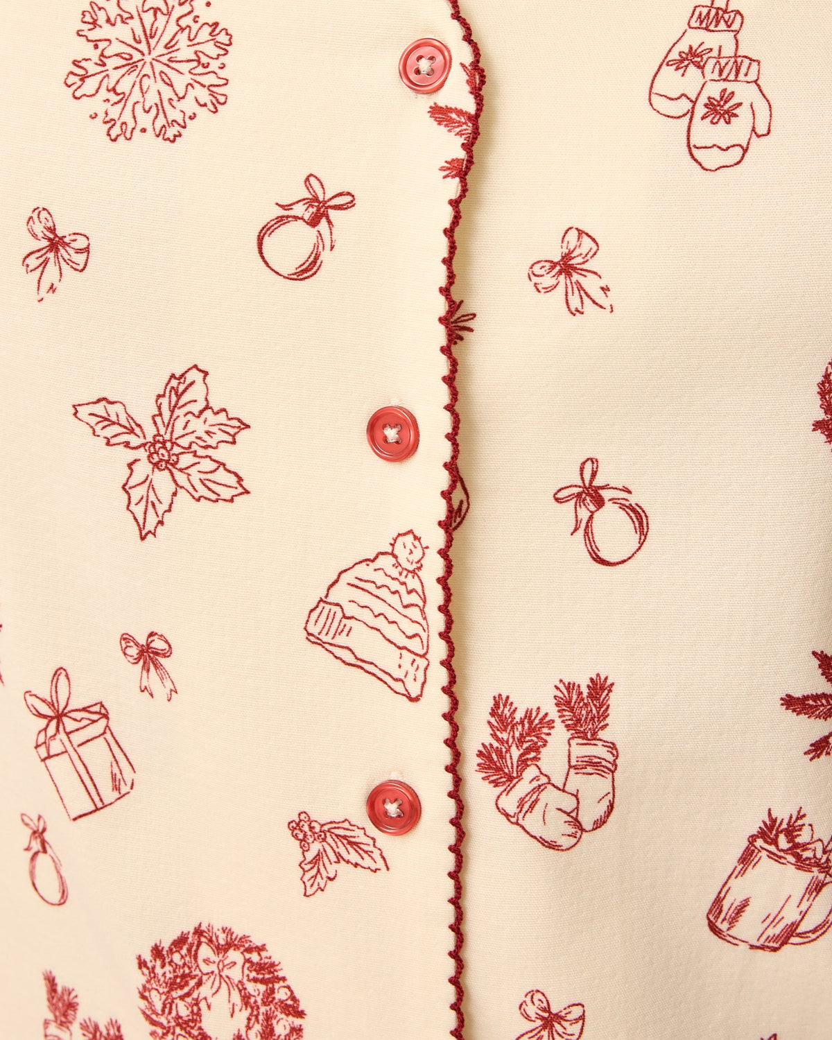 Close up of the button of the Cotton Bamboo Pajama Set in Cozy Day pattern on a beige background.