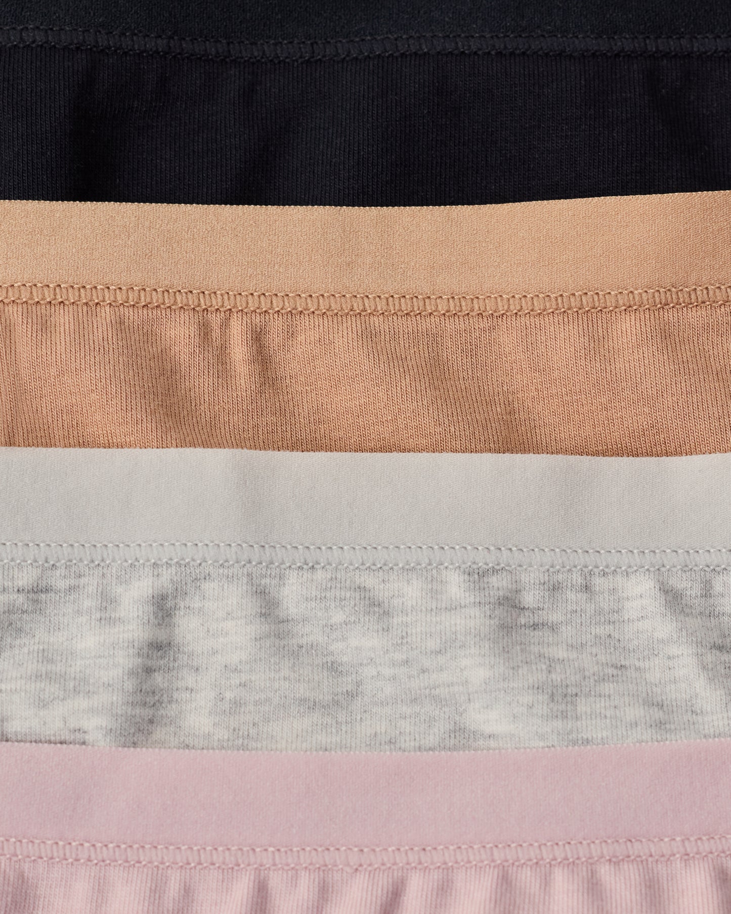 SoftStretch Undies in flat lay in four colors: Black, Buff, Grey Heather, Lilac Mist.