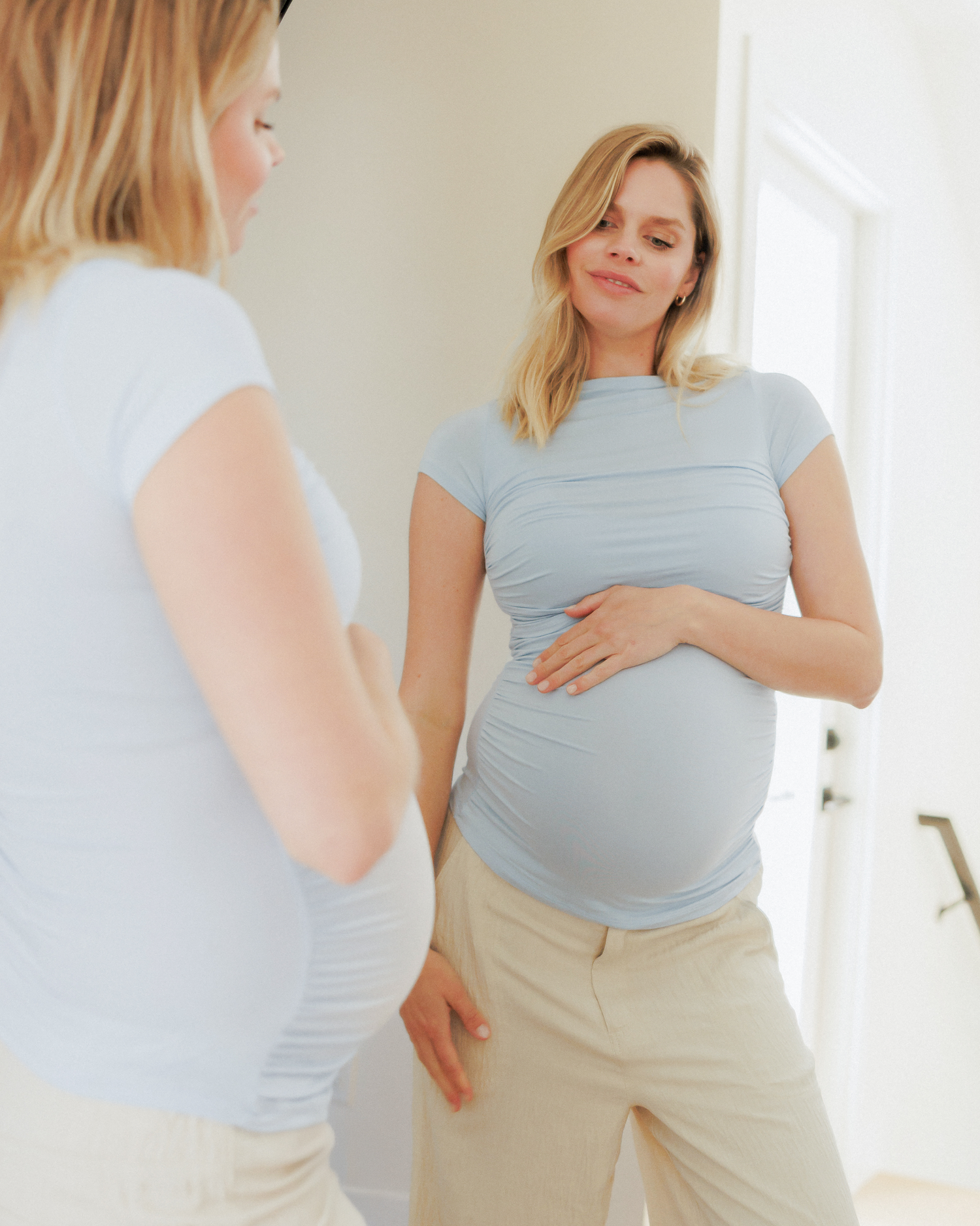 Front view of model standing in front of the mirror while wearing Kiera Boat Neck Maternity & Nursing Top in French Blue