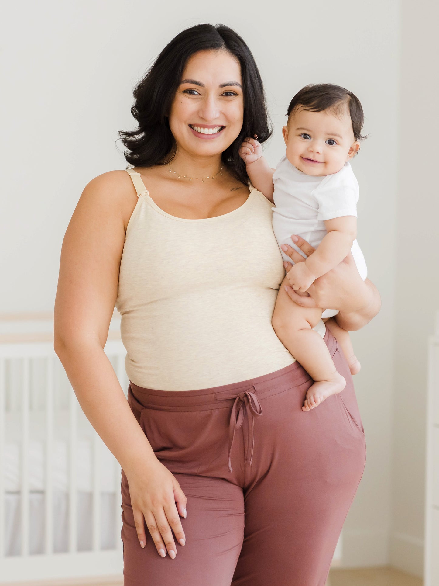 Model holding baby and wearing the Sublime® Bamboo Hands-Free Pumping & Nursing Camisole in Oatmeal Heather@model_info:Connie is wearing an X-Large Busty.