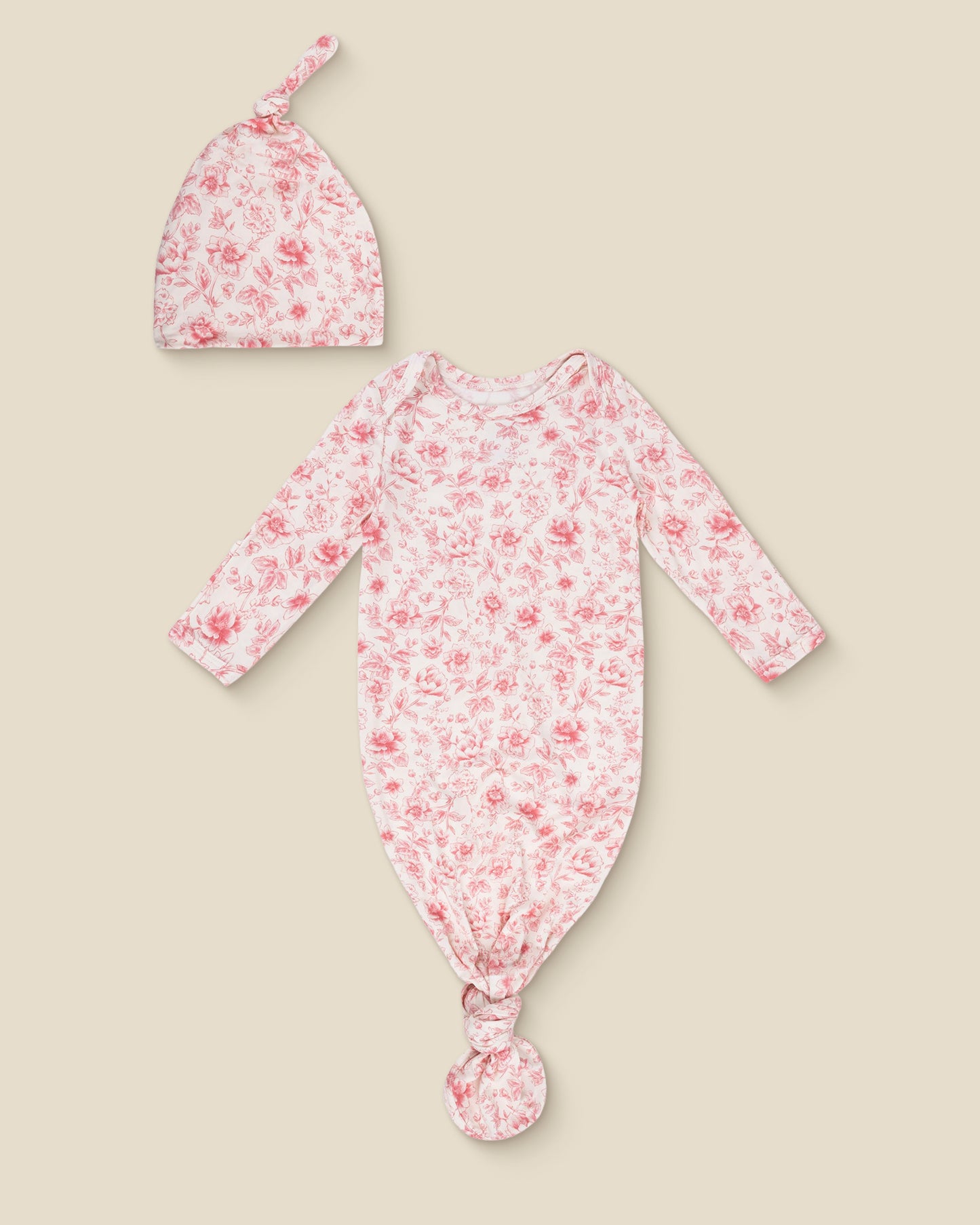 Floral Bamboo Knotted Baby Gown & Hat in pink toile with long-sleeve knotted top and matching hat on a beige background