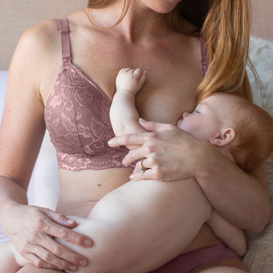 Model wearing the Lace Minimalist Nursing & Maternity Bra in Twilight breastfeeding her child. @model_info:Caitlin is wearing a Small.