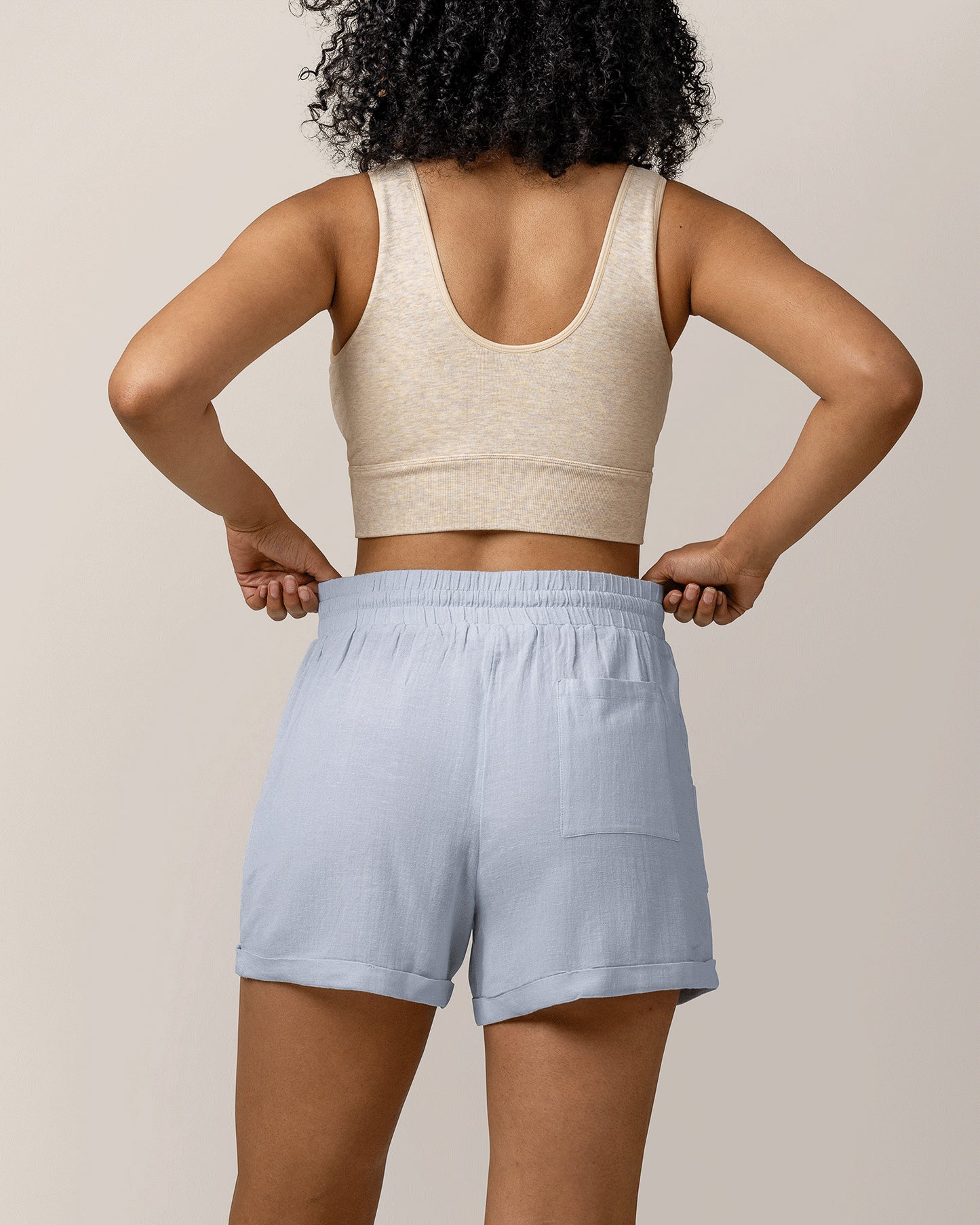 Cropped in back view of model wearing the Reese Linen Short in French Blue, paired with Sublime® Bamboo Maternity & Nursing Plunge Bra in Oatmeal Heather