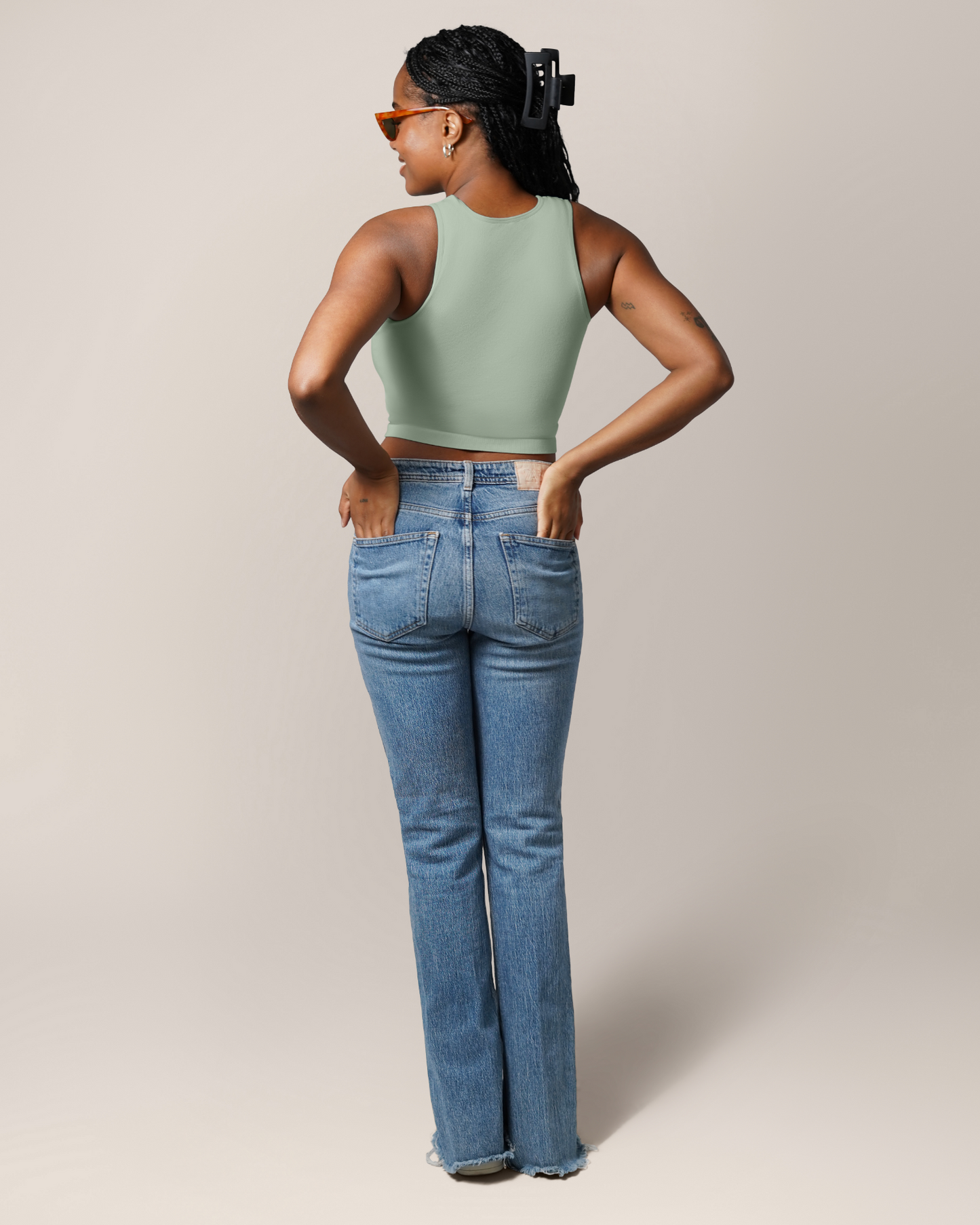 Full body back view of model wearing the Sublime® Bamboo Maternity & Nursing Longline Bra Top in Aqua Mist, paired with jeans