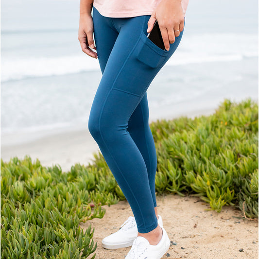 Model standing by the ocean wearing the Louisa Maternity & Postpartum Legging. @model_info:Cristy is wearing a Small.