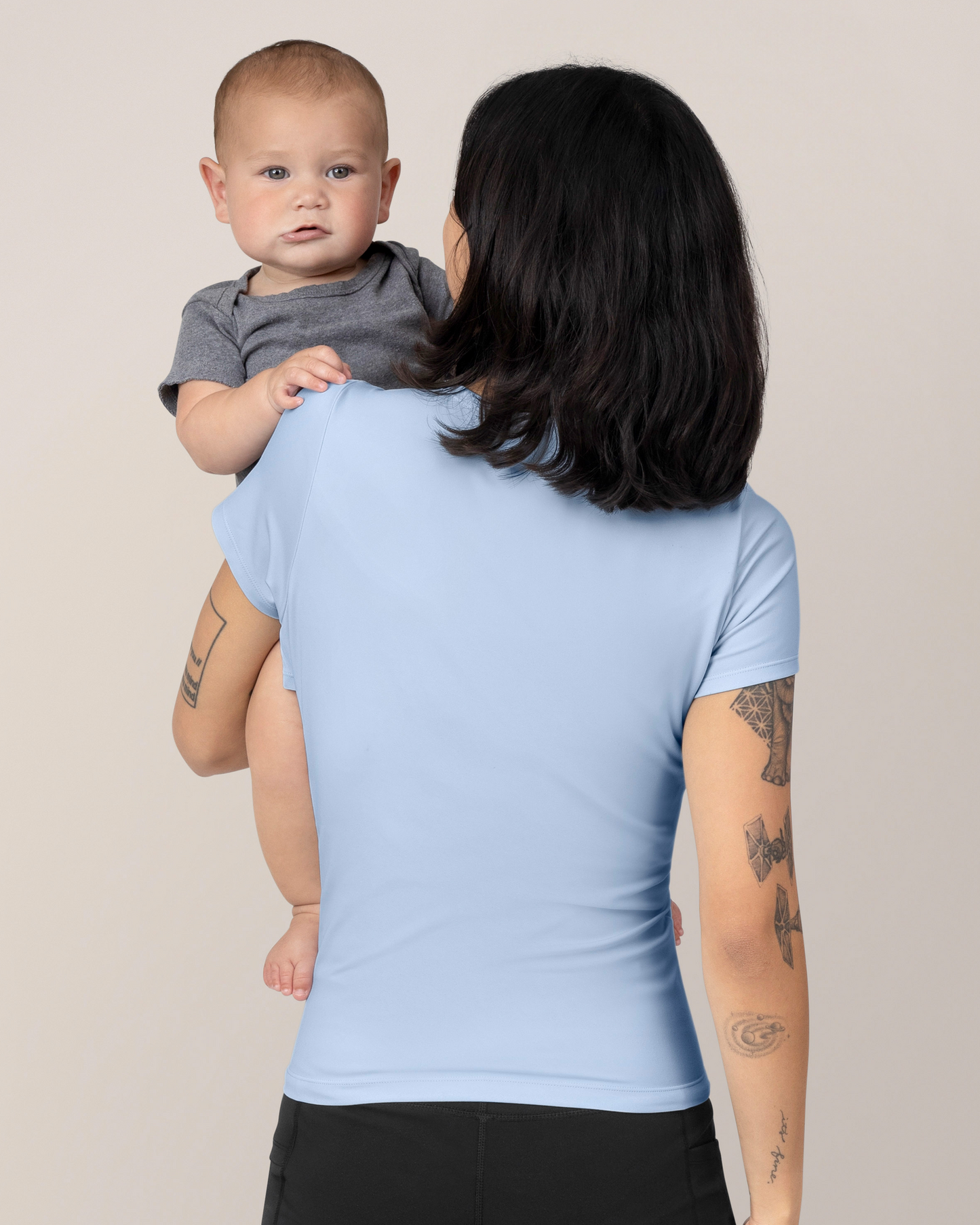 Back view of model wearing the Luna Active Cut Out Nursing Top in French Blue