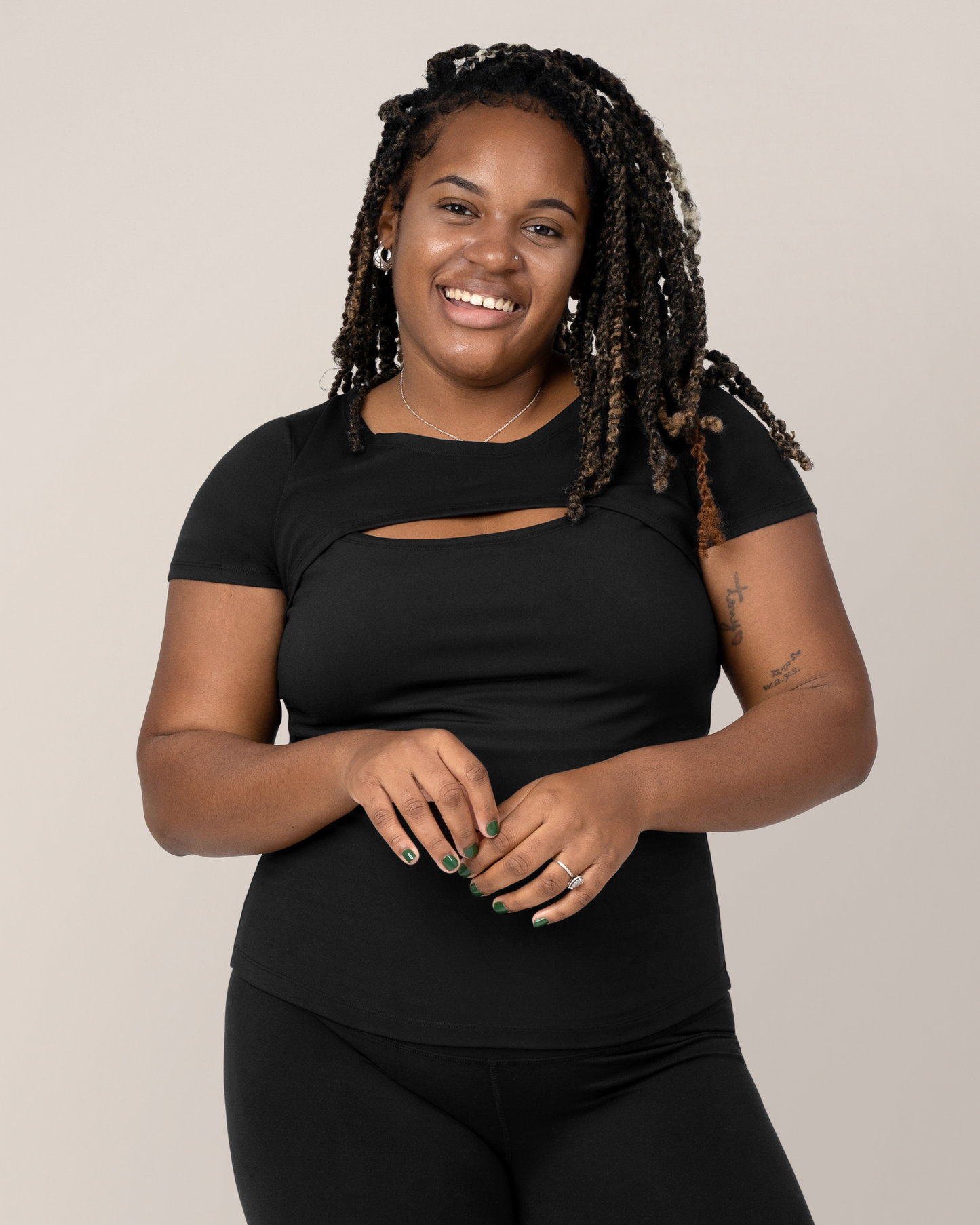 Front view of model wearing the Luna Active Cut Out Nursing Top in Black @model_info:Tonia is wearing a Large.