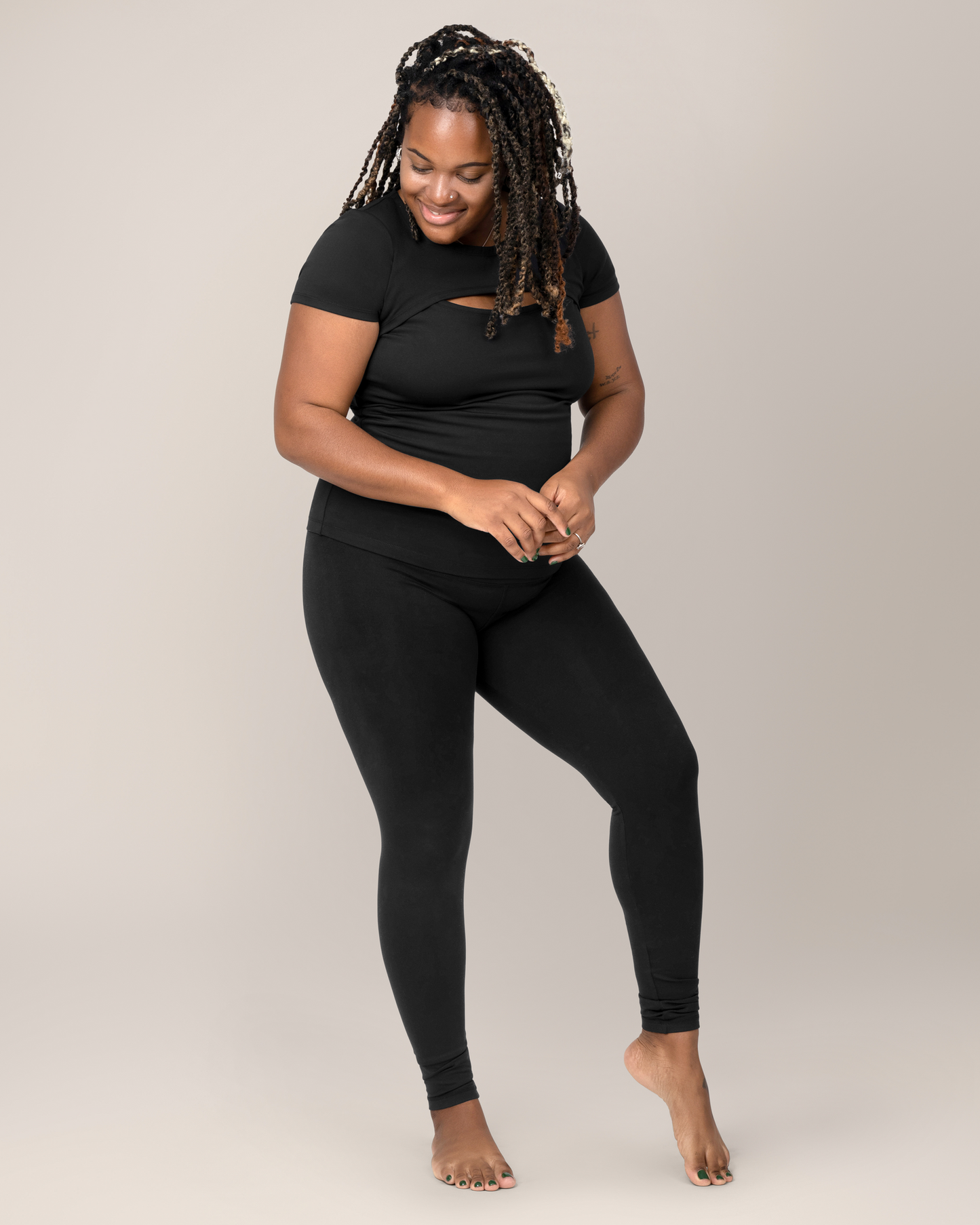 Model wearing the Luna Active Cut Out Nursing Top in Black with matching leggings