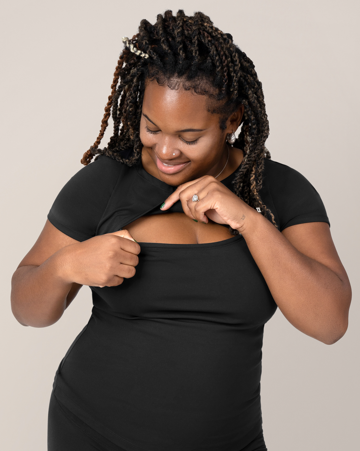Front view of model wearing the Luna Active Cut Out Nursing Top in Black while showing nursing access
