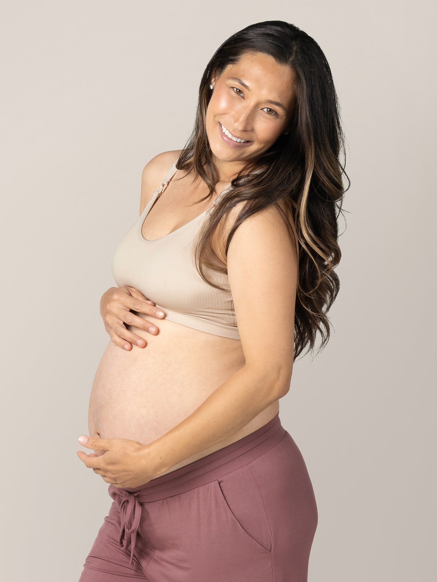 3/4 view of pregnant model wearing the Mia Maternity & Nursing Lounge Bra in Stone.