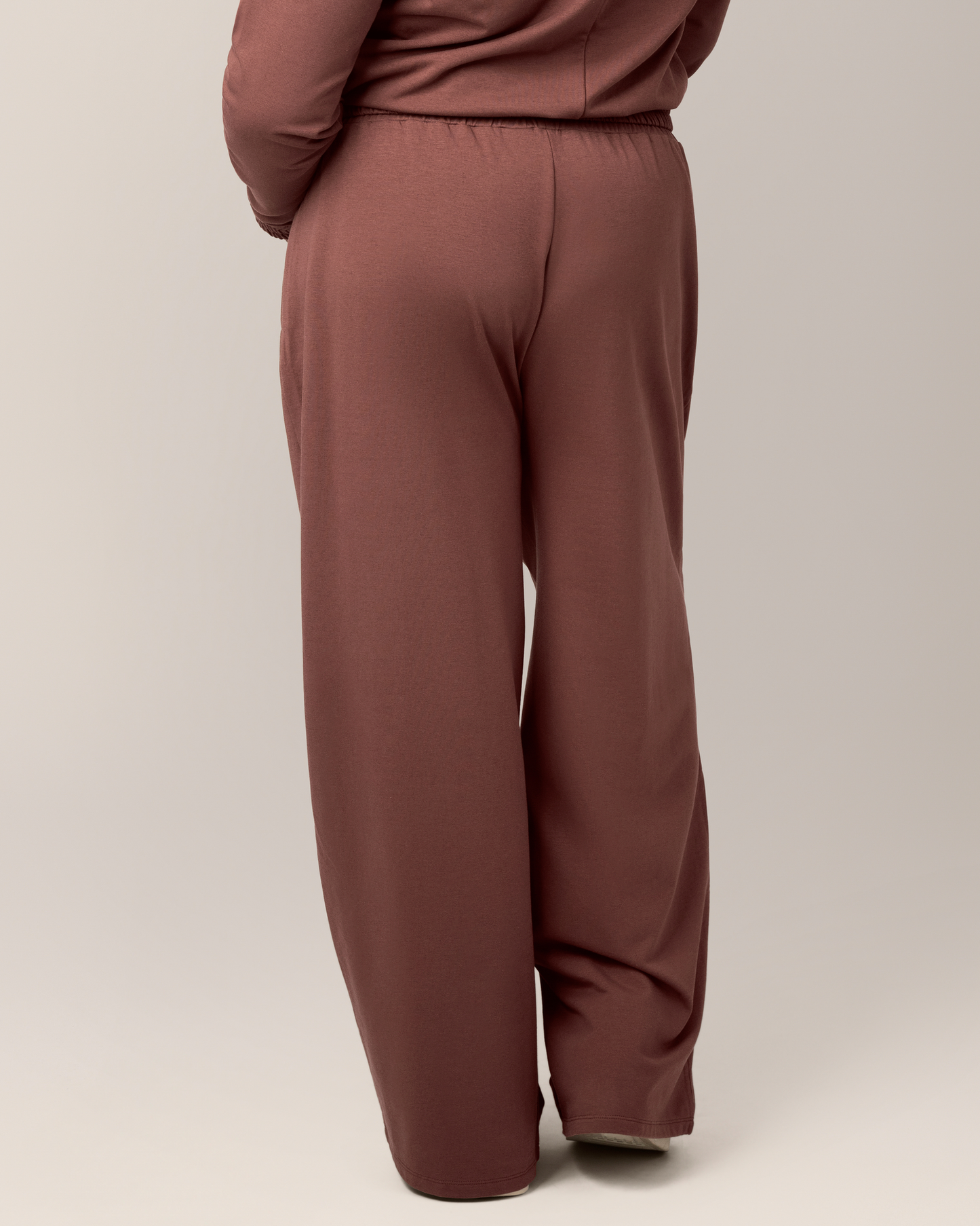 Back view of model wearing the Mila High-Waisted Wide Leg Pant in Redwood