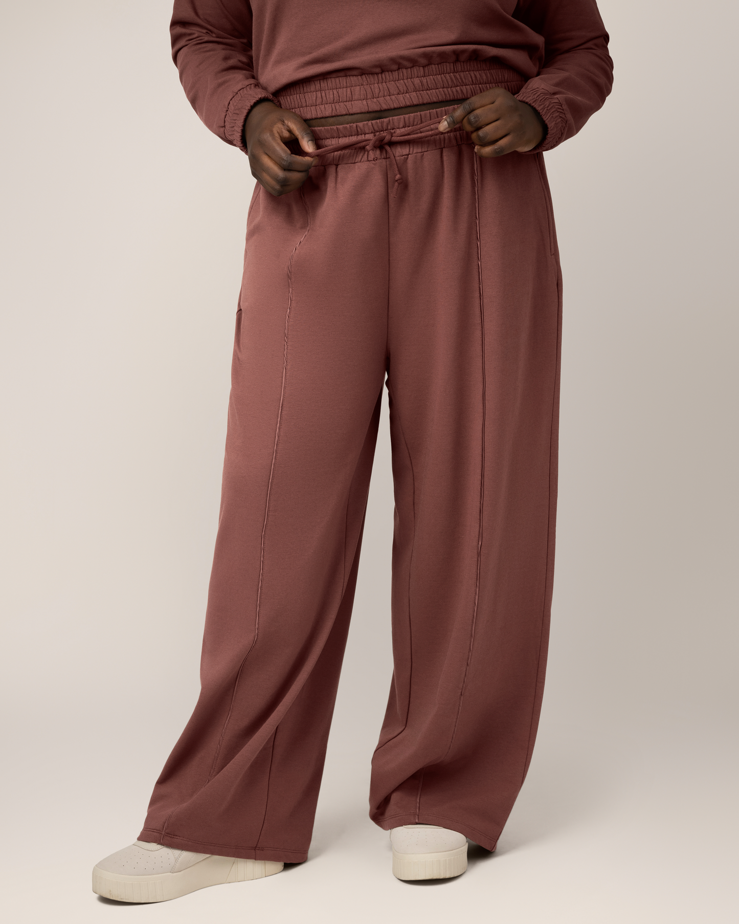 Front view of model wearing the Mila High-Waisted Wide Leg Pant in Redwood. @model_info:Bintou is 5'9" and wearing an X-Large Long.