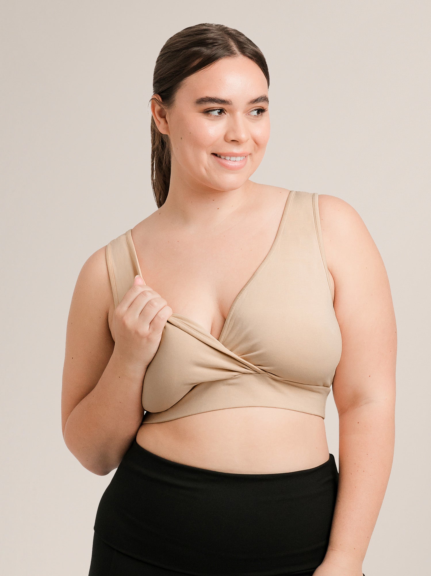 Model wearing the Organic Cotton Sleep & Nursing Bra in Beige showing nursing access