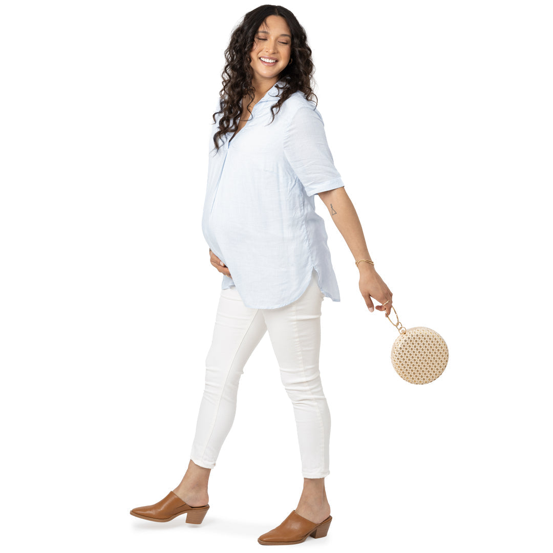 Pregnant model wearing the Oversized Nursing & Maternity Collared Top with a bag