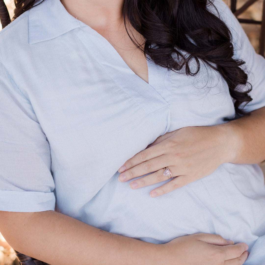 Closeup of a pregnant model wearing the Oversized Nursing & Maternity Collared Top