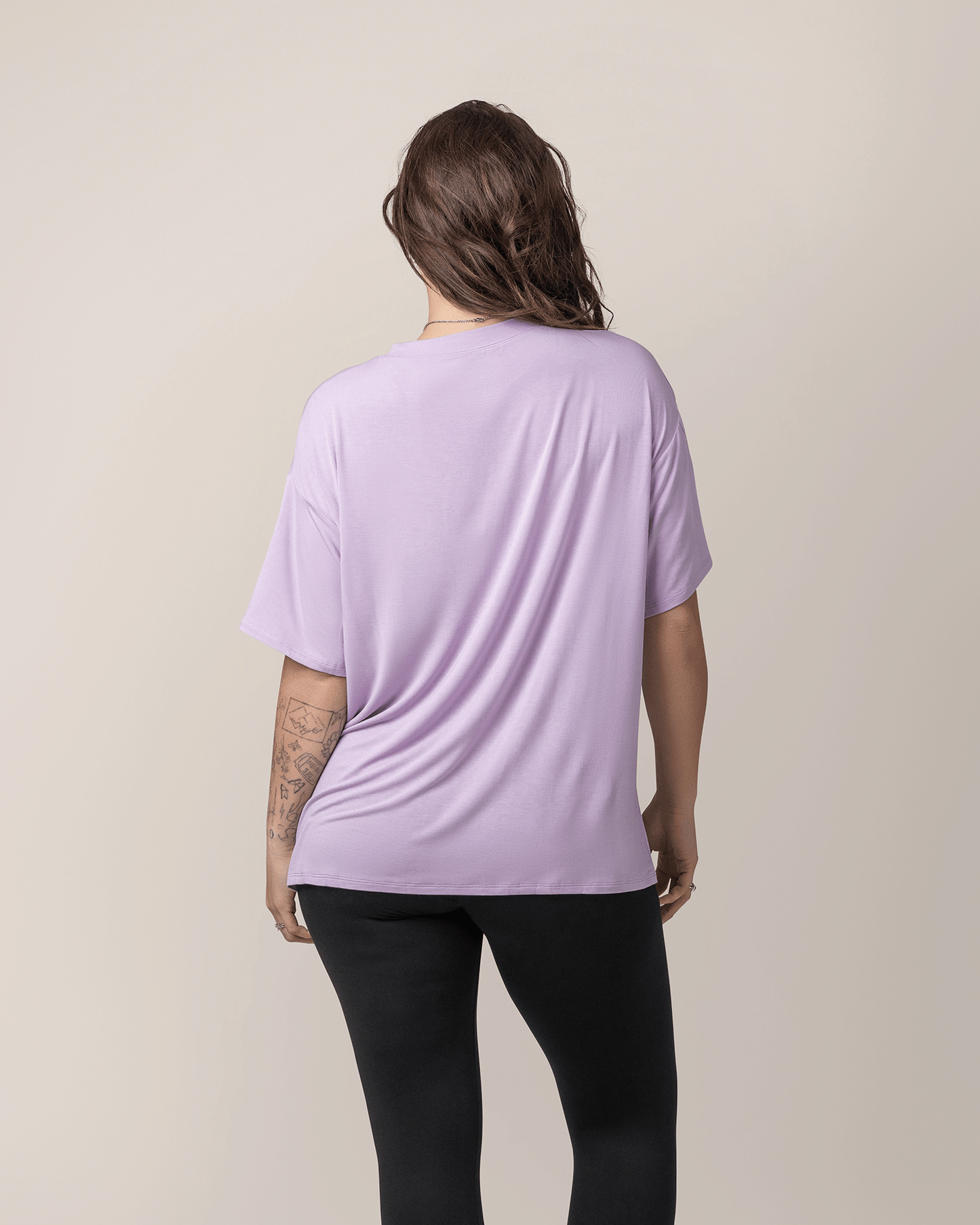 Back view of model wearing Oversized Graphic Tee in For All I'm Worth