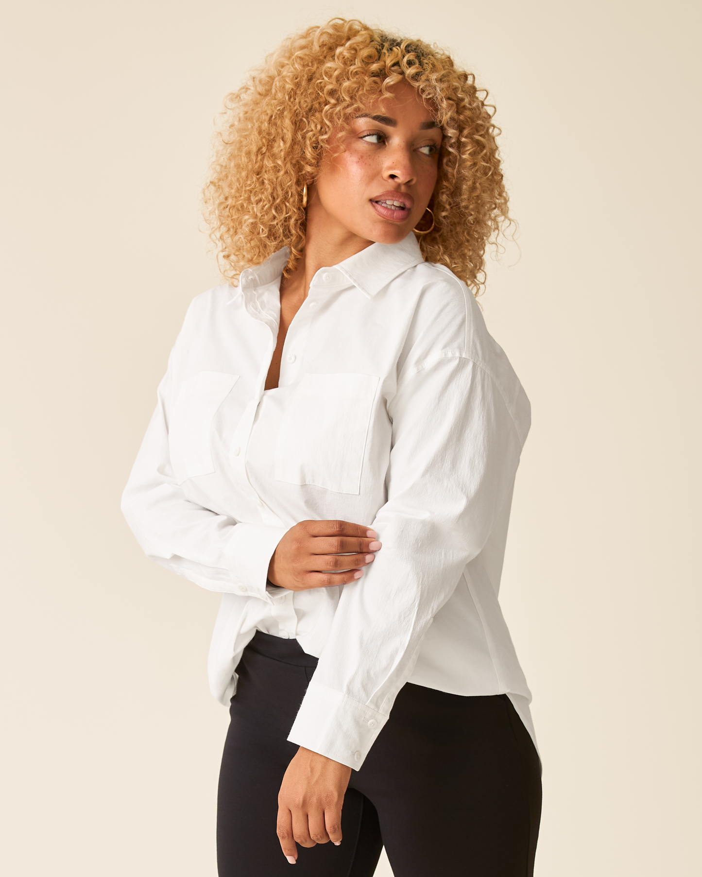 Side view of model wearing Poplin Maternity & Nursing Button Up Shirt in White