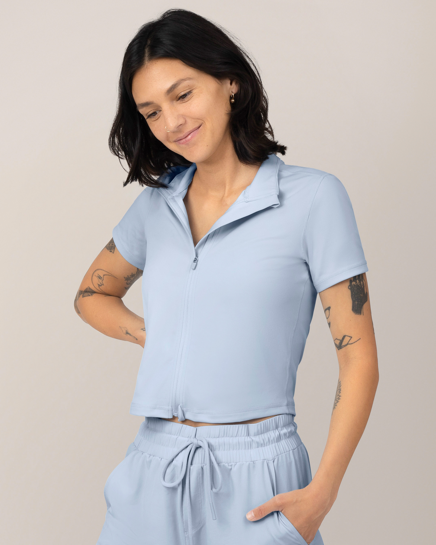 Front view of Model wearing the Presley Active Zip Front Nursing Top in Light Blue