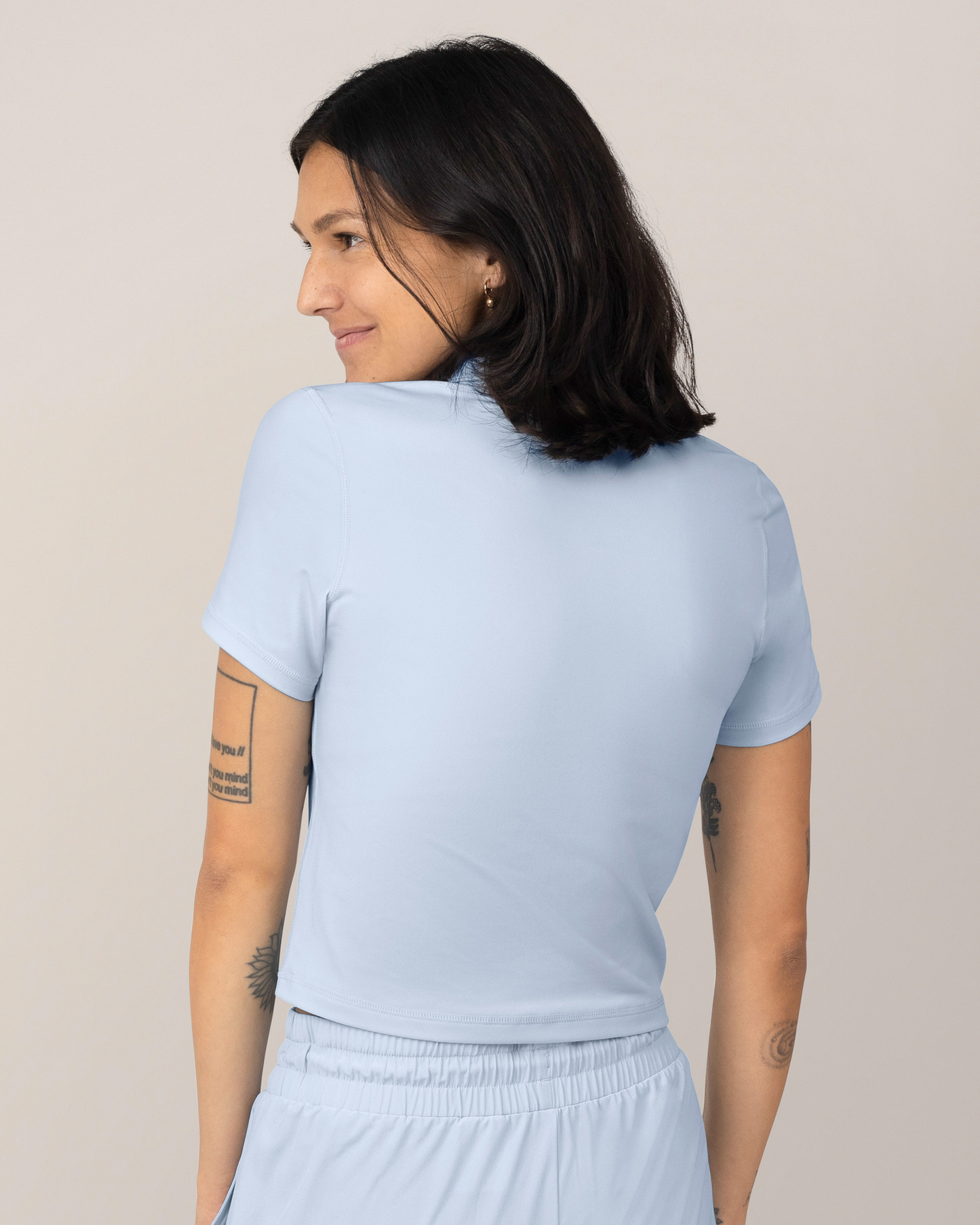 Back view of Model wearing the Presley Active Zip Front Nursing Top in Light Blue