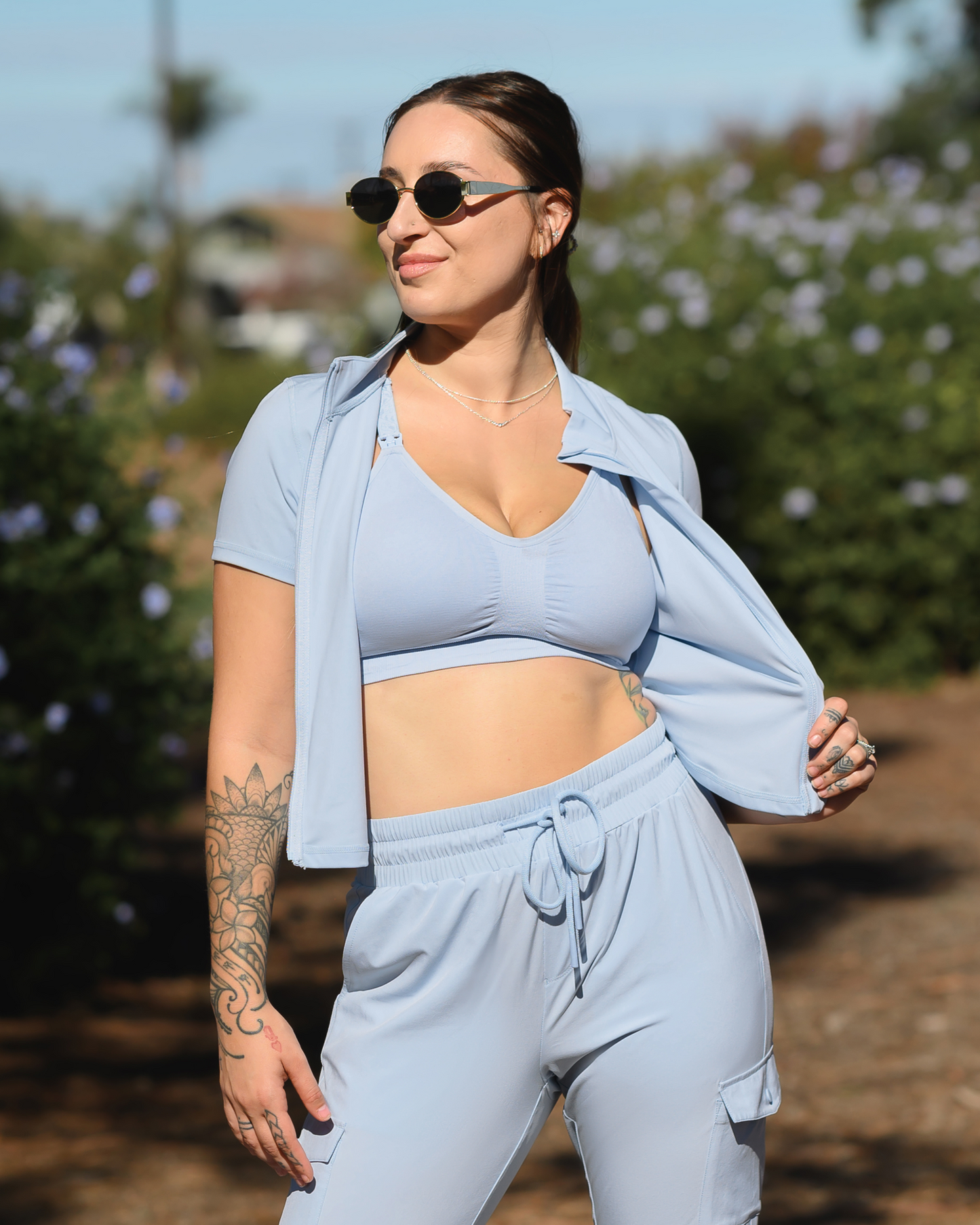 Model standing outside wearing the Sublime® Hands-Free Pumping & Nursing Sports Bra in French Blue with matching Presley Active Zip Up Top @model_info:Anna is wearing a Medium Busty.