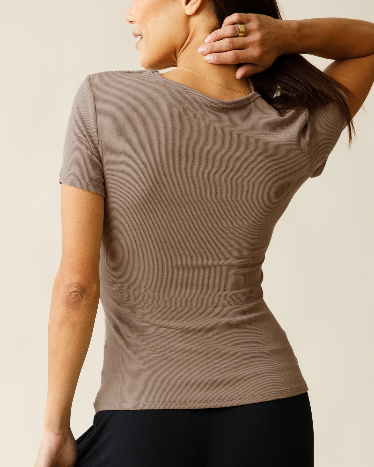 Back view of woman wearing the Ribbed Bamboo Crew Neck Nursing T-shirt in Taupe