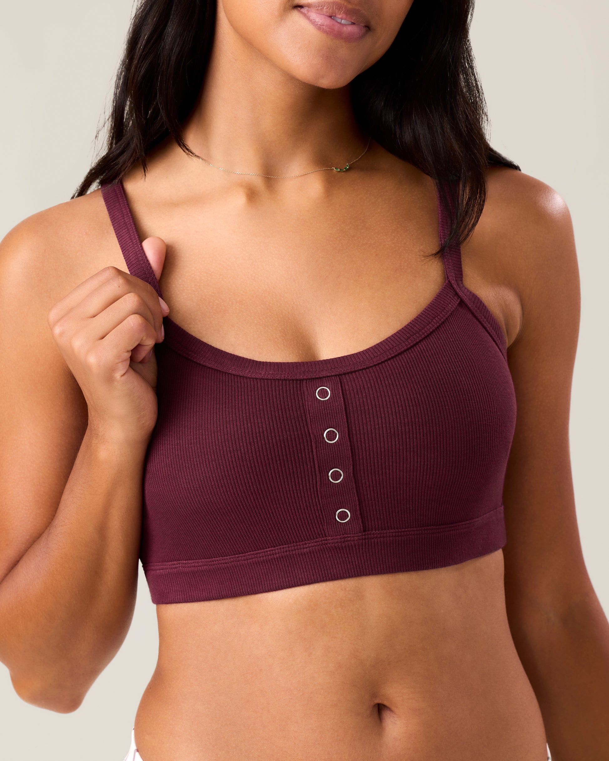 Woman wearing the Ribbed Bamboo Pumping Bralette in Deep Burgundy@model_info:Nemesis is wearing a Medium.