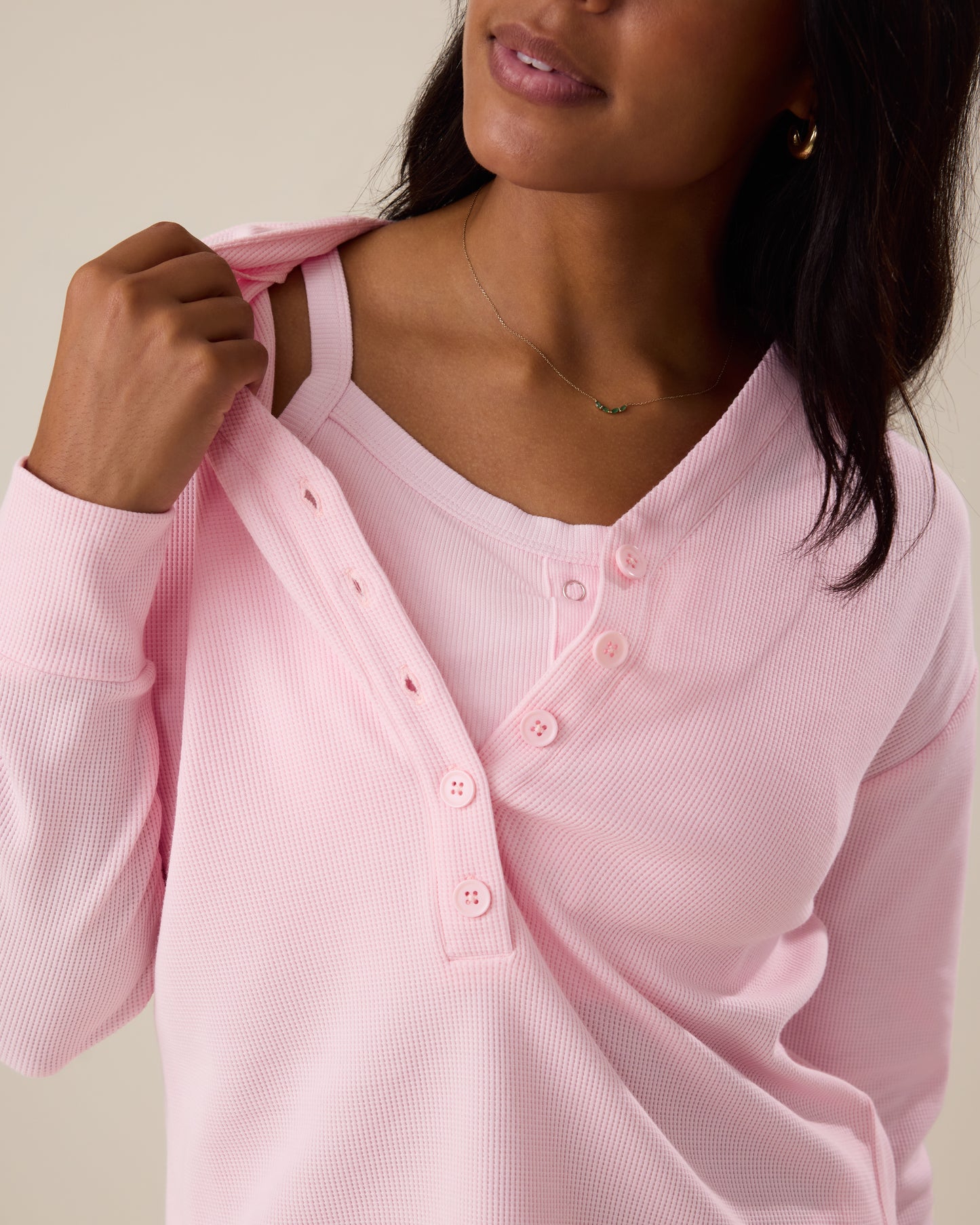 Woman wearing the Waffle Maternity & Nursing Lounge Set in pale pink with matching bra underneath