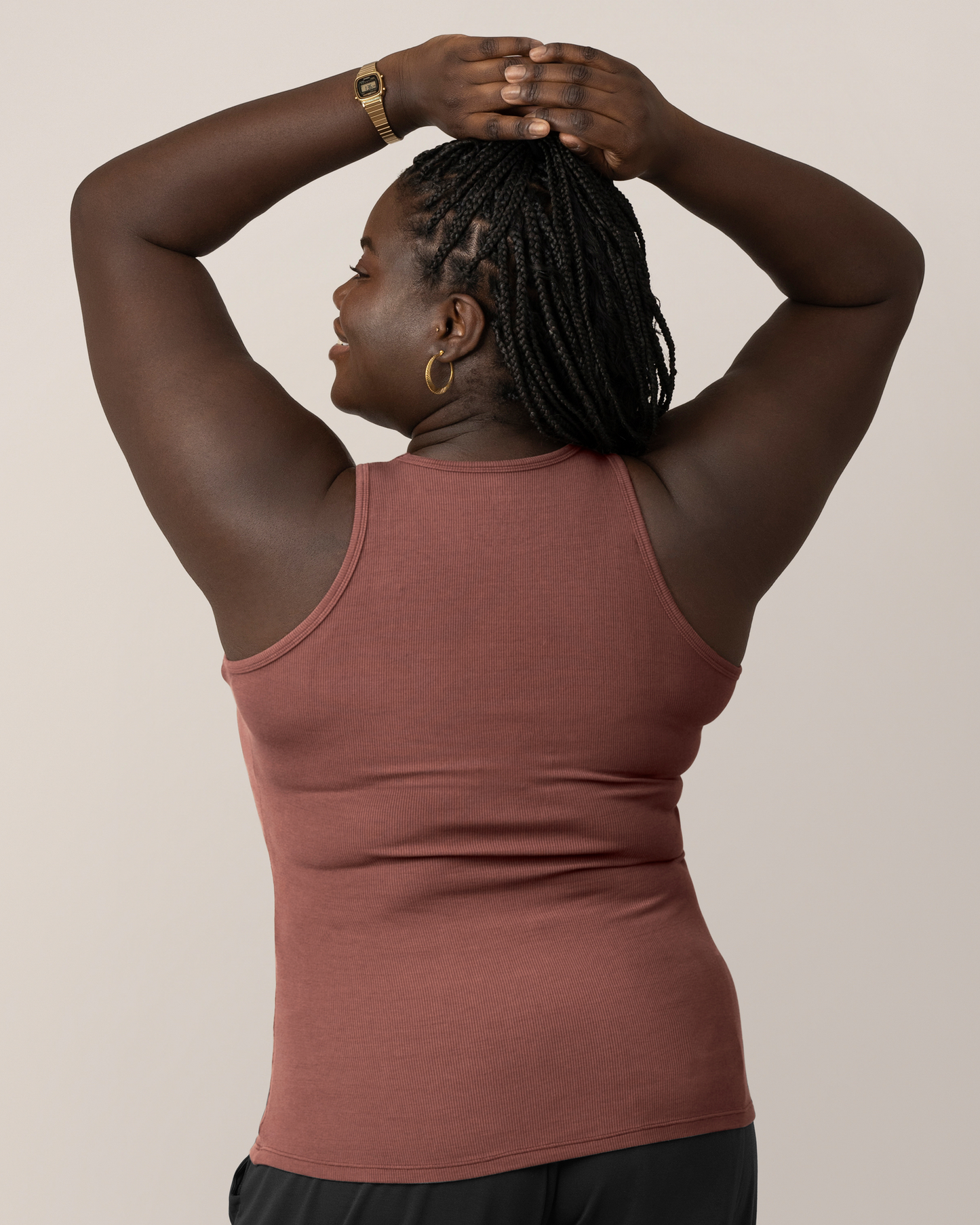 Back view of model wearing the Ribbed Bamboo Racerback Nursing Tank in Redwood, with hands on top of head
