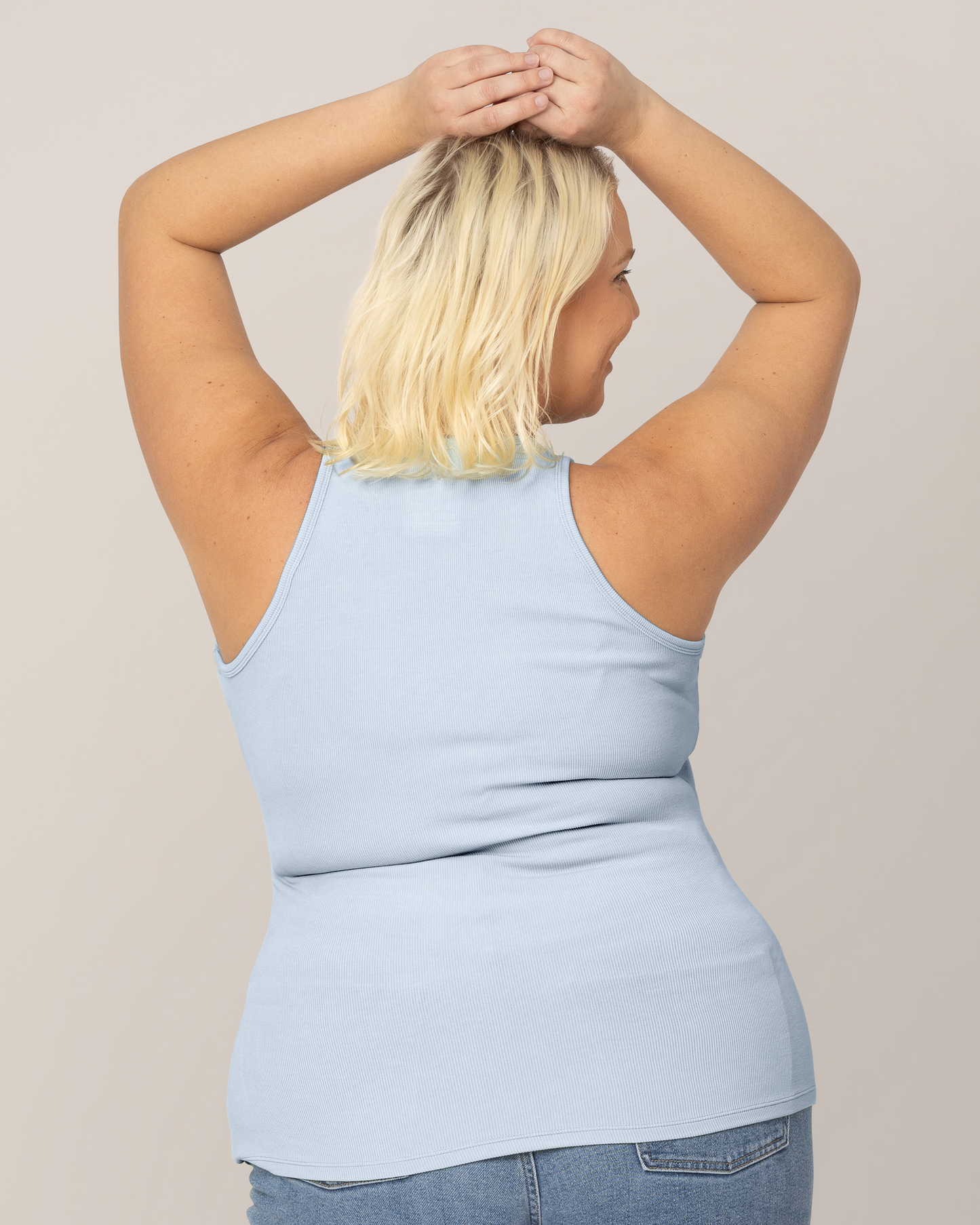 Back view of model wearing the Ribbed Bamboo Racerback Nursing Tank in French Blue