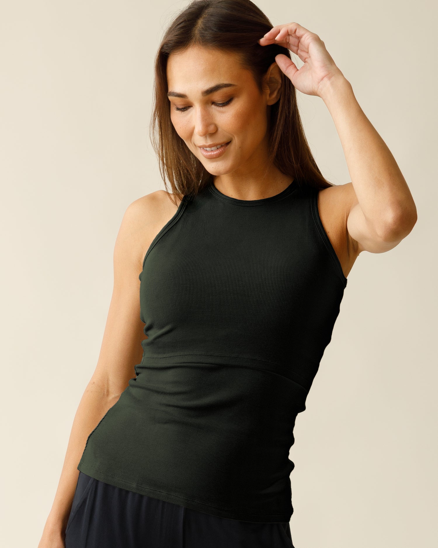 Front view of woman wearing the Ribbed Bamboo Racerback Nursing Tank in Thyme@model_info:Lisa is wearing a Small.