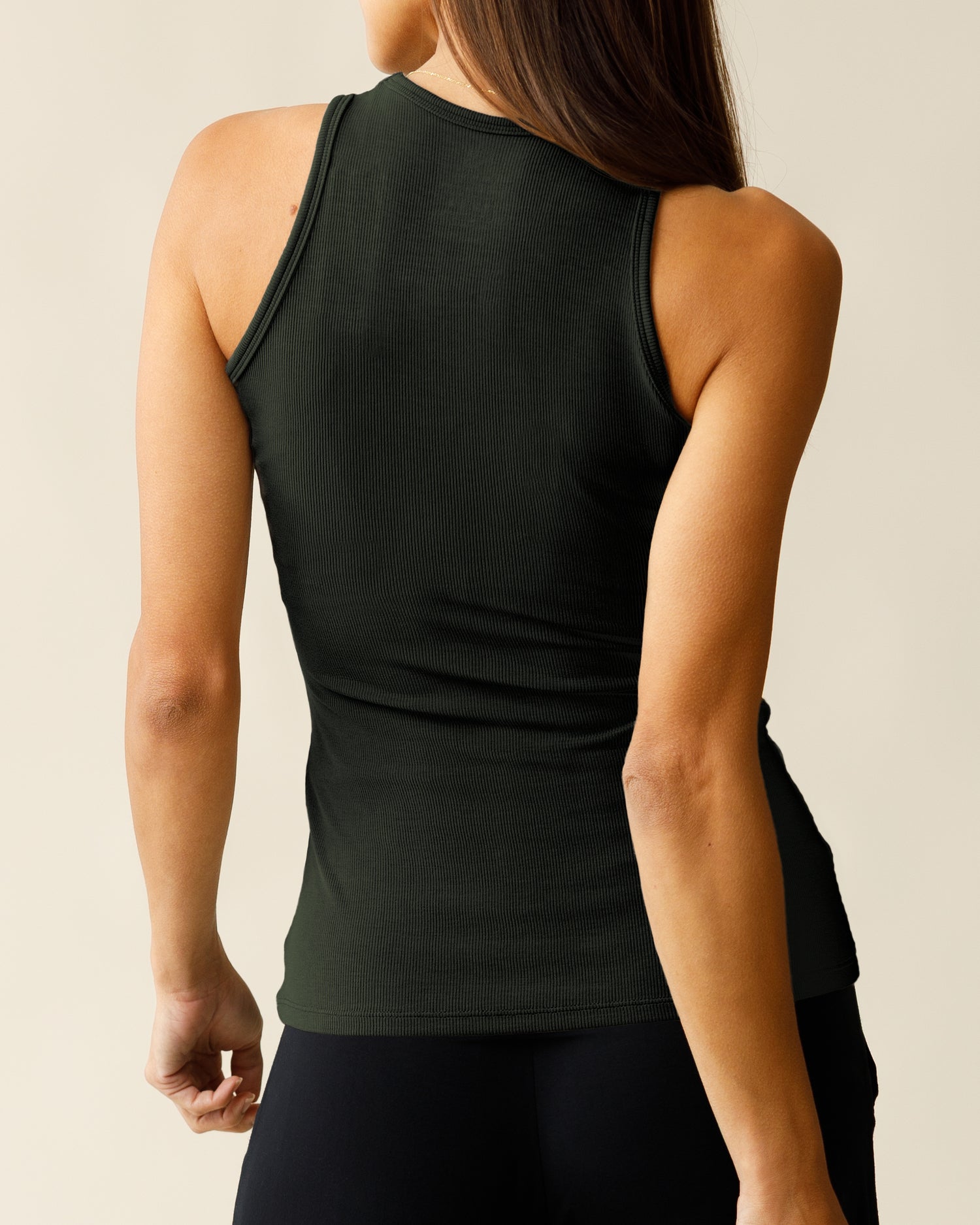 Front view of woman wearing the Ribbed Bamboo Racerback Nursing Tank in Thyme, show back.
