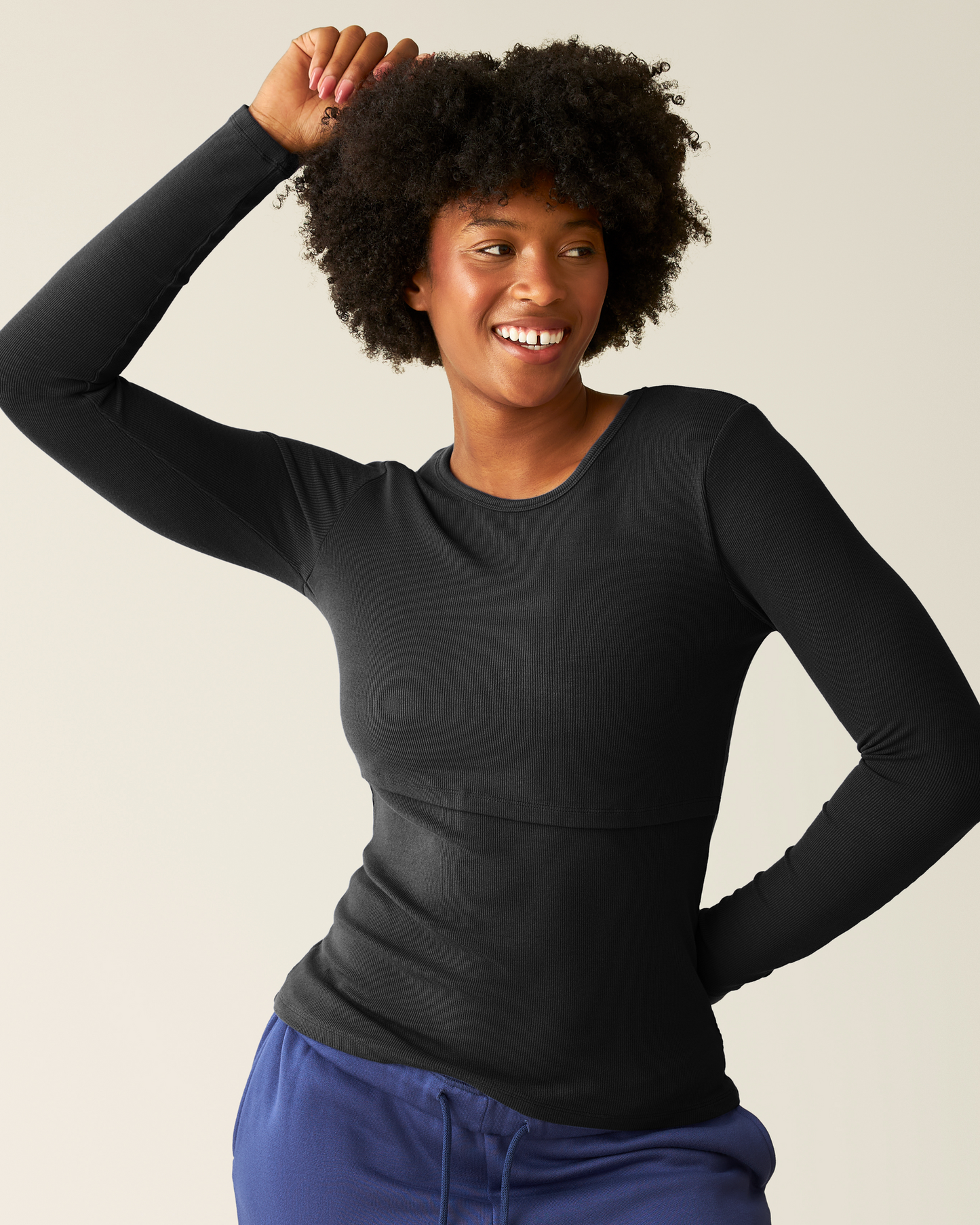 Woman wearing the Ribbed Bamboo Long Sleeve Nursing T-shirt in Black@model_info:Kyra is wearing a Small.