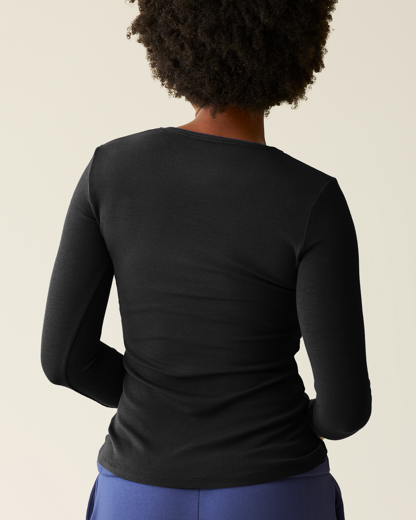 Woman wearing the Ribbed Bamboo Long Sleeve Nursing T-shirt in Black, showing back of top