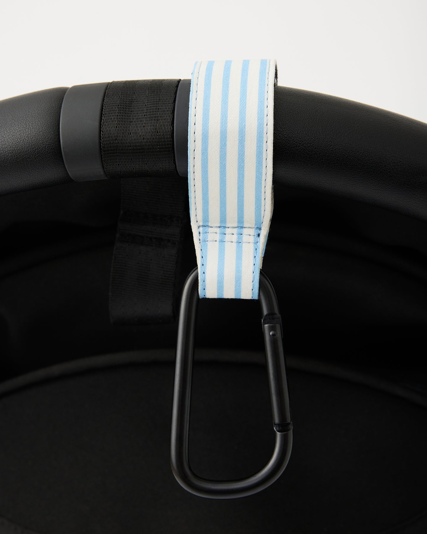 Close up of Stroller Party Clips (2-Pack) in Blue Pinstripe hanging over handlebar of stroller, on a white background.