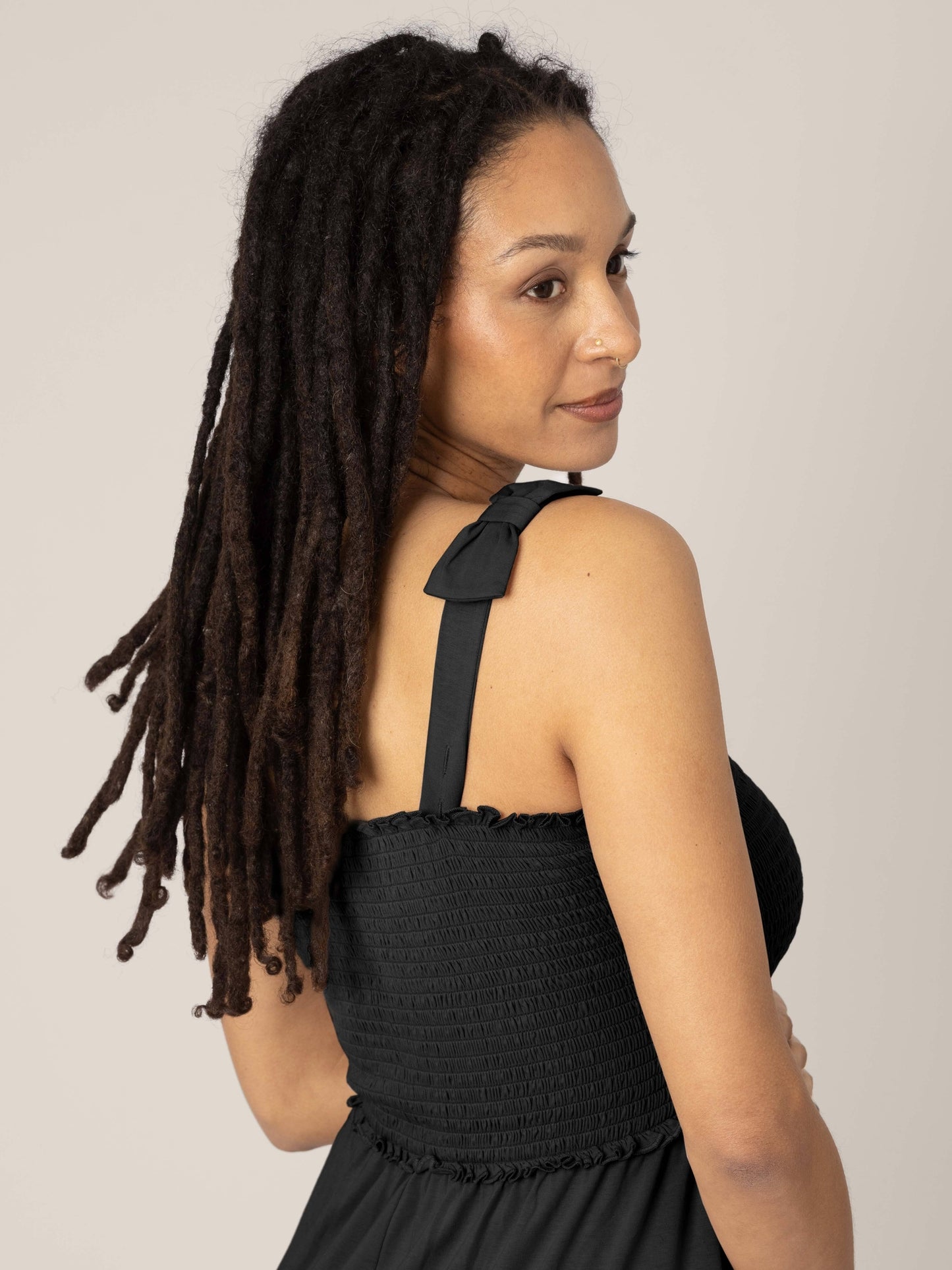Model wearing the Sienna Smocked Maternity & Nursing Dress in black showing the tie straps