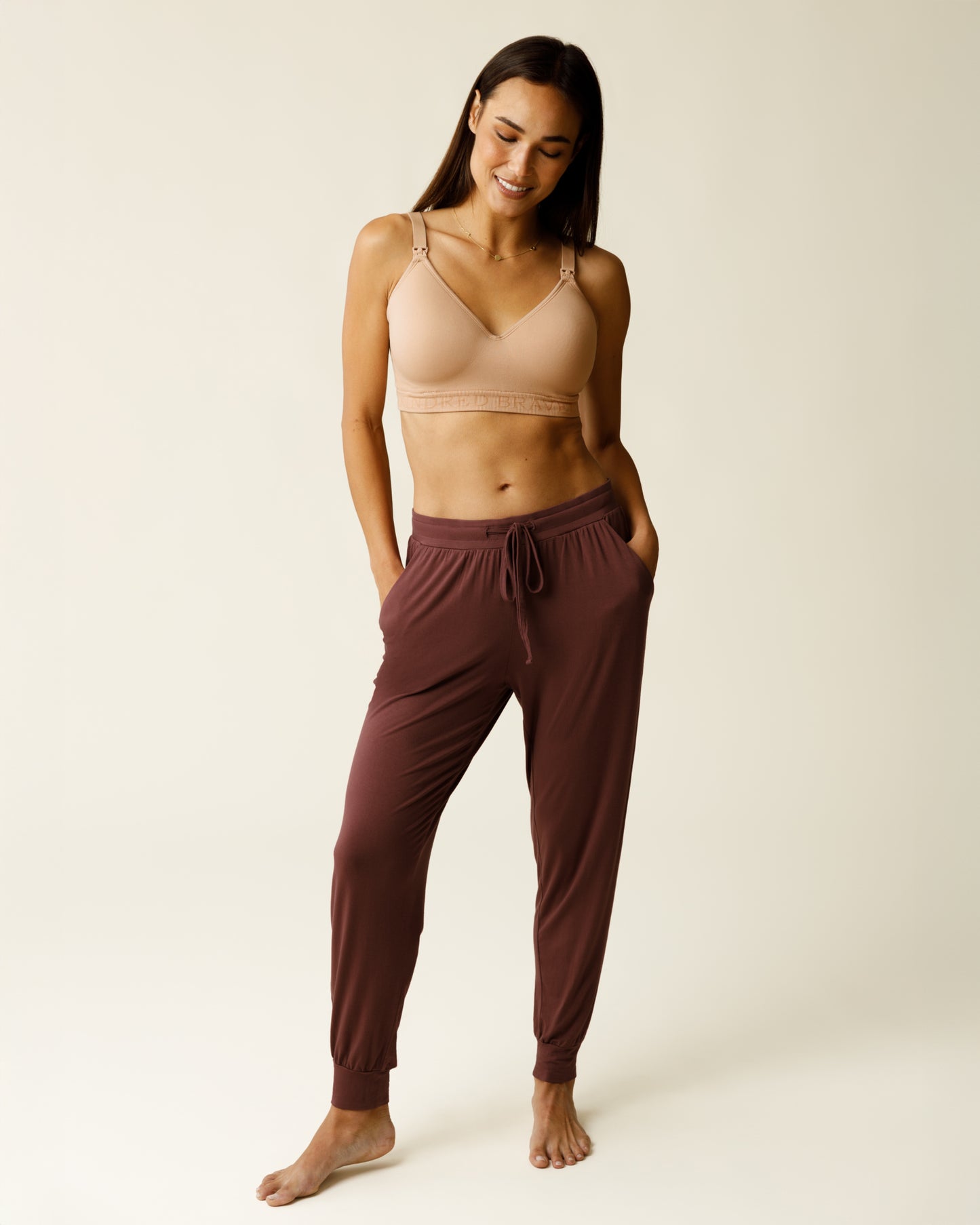 Woman wearing the Everyday Lounge Jogger in Redwood, paired with beige bra@model_info:Lisa is 5'6" and wearing a Small.