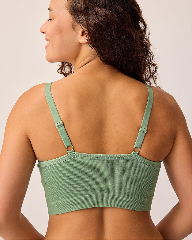 Back view of model wearing Sublime® Bamboo Hands-Free Pumping Lounge & Sleep Bra in Sage, on a beige background.