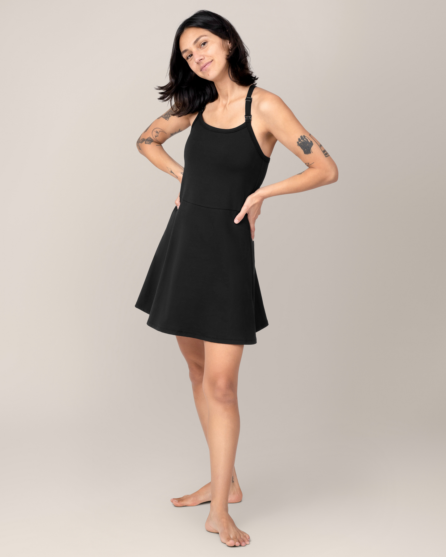 Front view of model wearing the Stevie Active Racerback Nursing Dress in Black @model_info:Megan is 5'7" and wearing a Small.