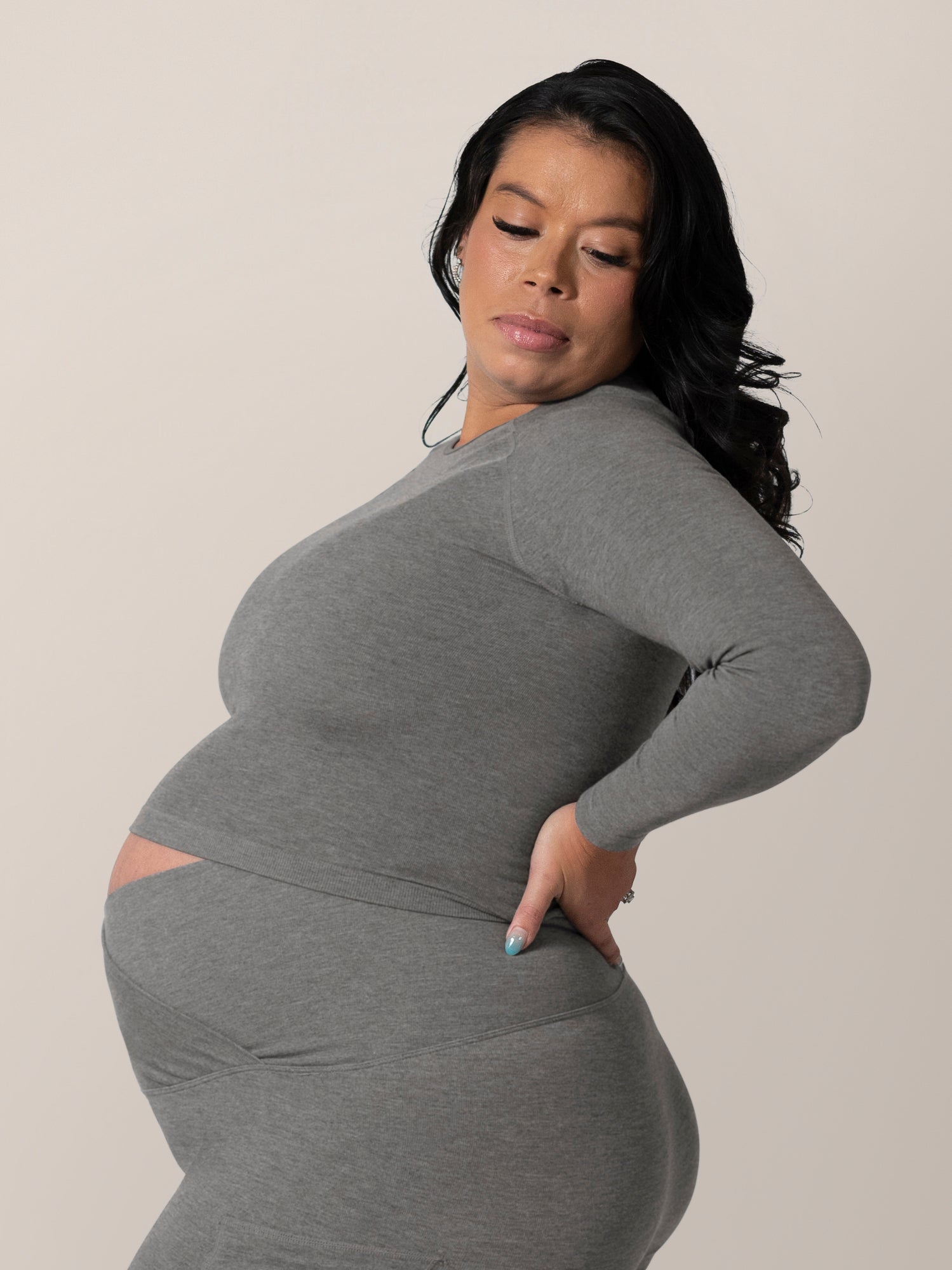 Side view of model wearing the Sublime® Bamboo Maternity & Nursing Cropped Long Sleeve Top in Charcoal.