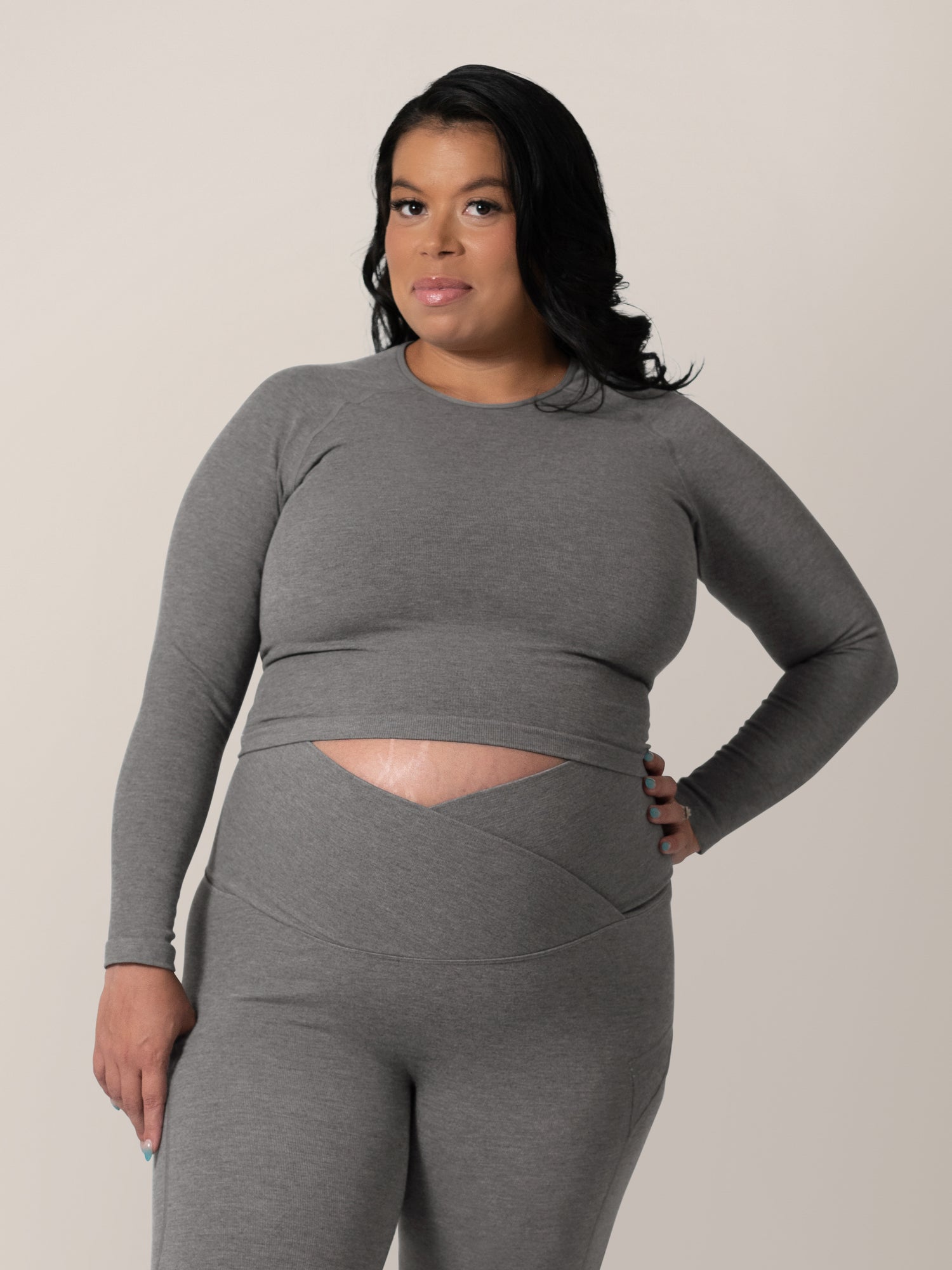Front view of model wearing the Sublime® Bamboo Maternity & Nursing Cropped Long Sleeve Top in Charcoal. @model_info:Christina is wearing a Medium Busty.