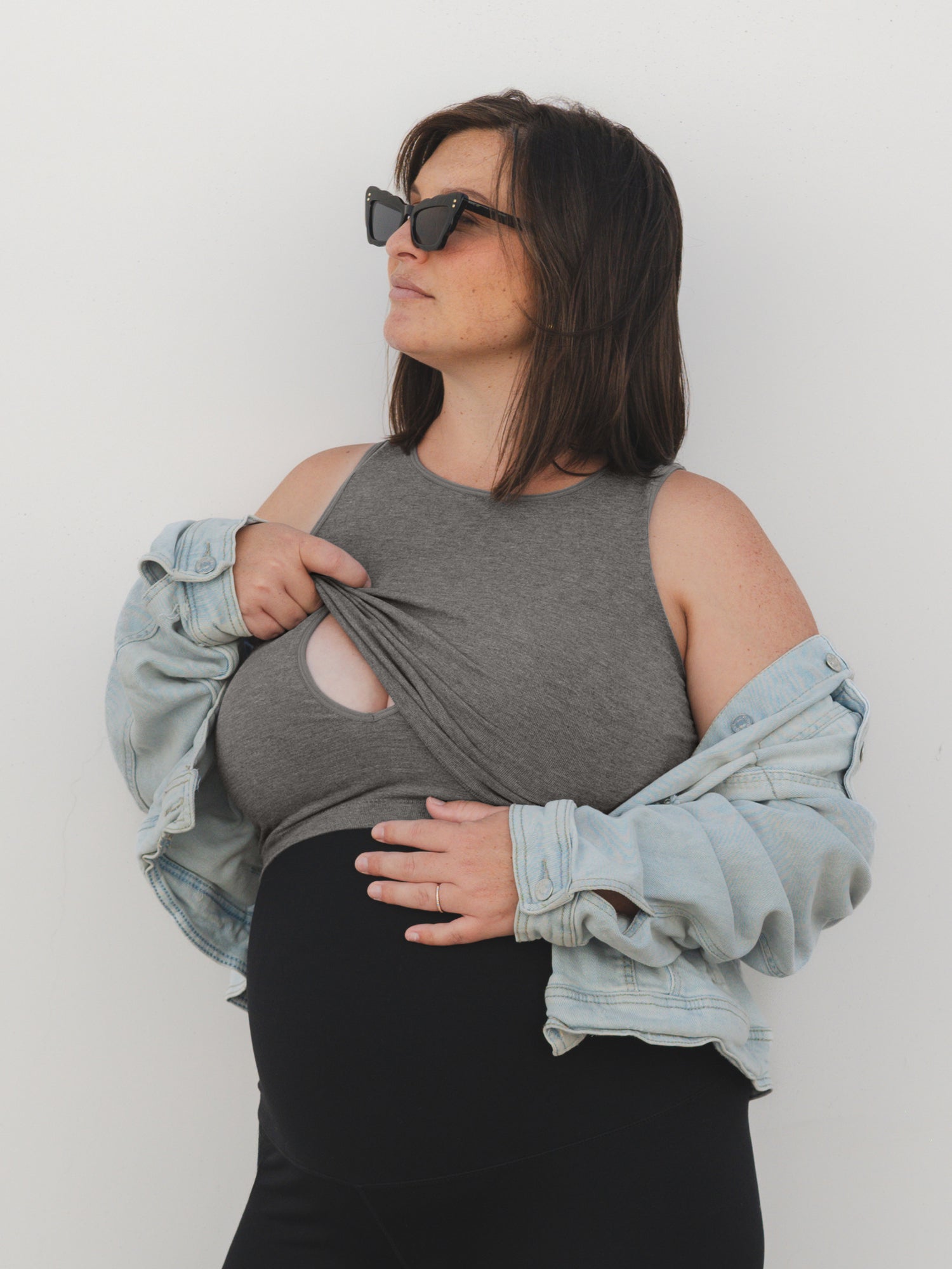 Full body view of model wearing the Sublime® Bamboo Maternity & Nursing Longline Bra in Charcoal, paired with an open slouched denim jacket