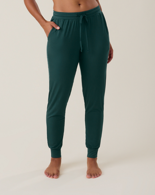 Woman wearing the Everyday Lounge Jogger in evergreen with hand in pocket@model_info:Nemesis is wearing a Small.