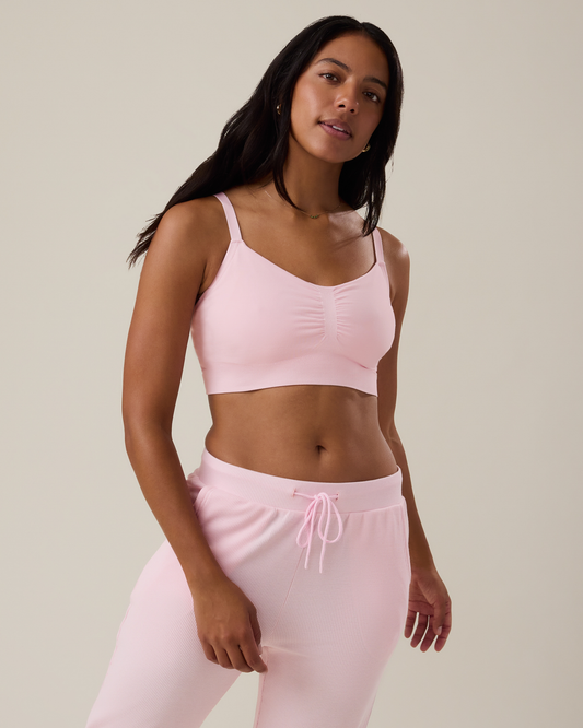 Woman wearing the Sublime® Bamboo Hands-Free Pumping Lounge & Sleep Bra in pale pink with matching bottoms@model_info:Nemesis is wearing a Medium.