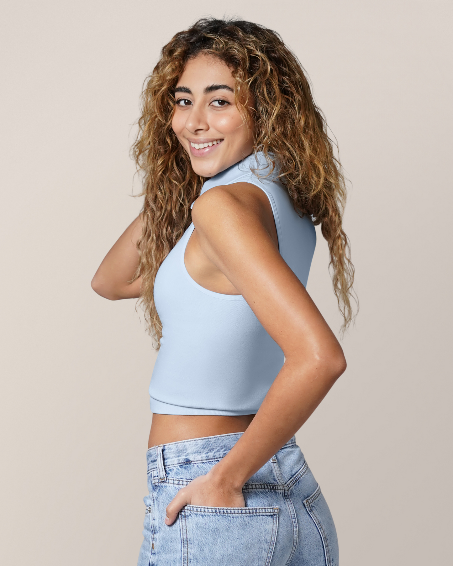 Angled back view of model wearing the Sublime® Bamboo Collared Maternity & Nursing Longline Bra Top in French Blue, paired with jeans