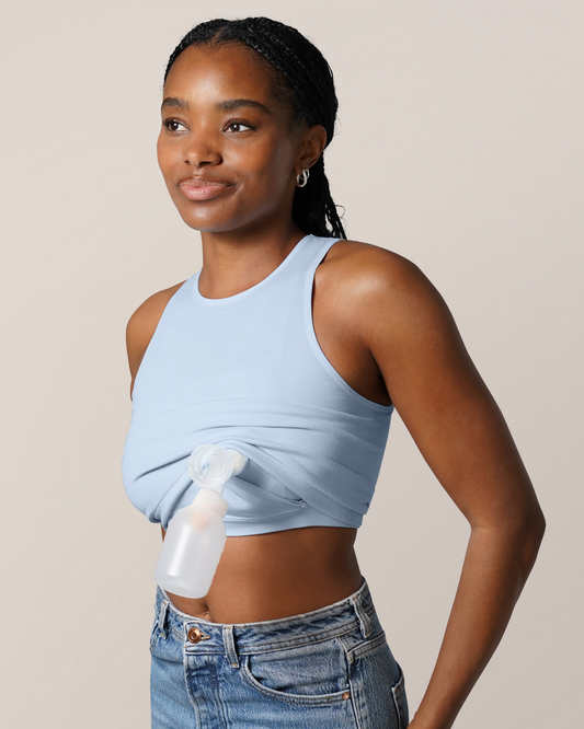 3/4 view of model wearing  the Sublime® Bamboo Hands-Free Pumping Longline Bra Top in French Blue, showing one pump flange with bottle inserted @model_info:Josie is wearing a Small Busty.