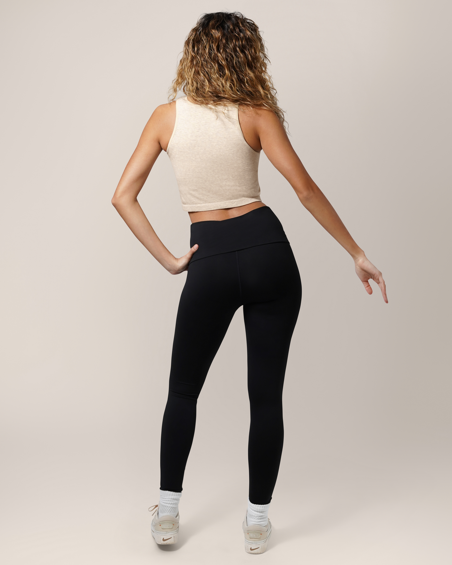 Back full body view of model wearing the Sublime® Bamboo Hands-Free Pumping Longline Bra Top in Oatmeal Heather, paired with the Louisa Legging