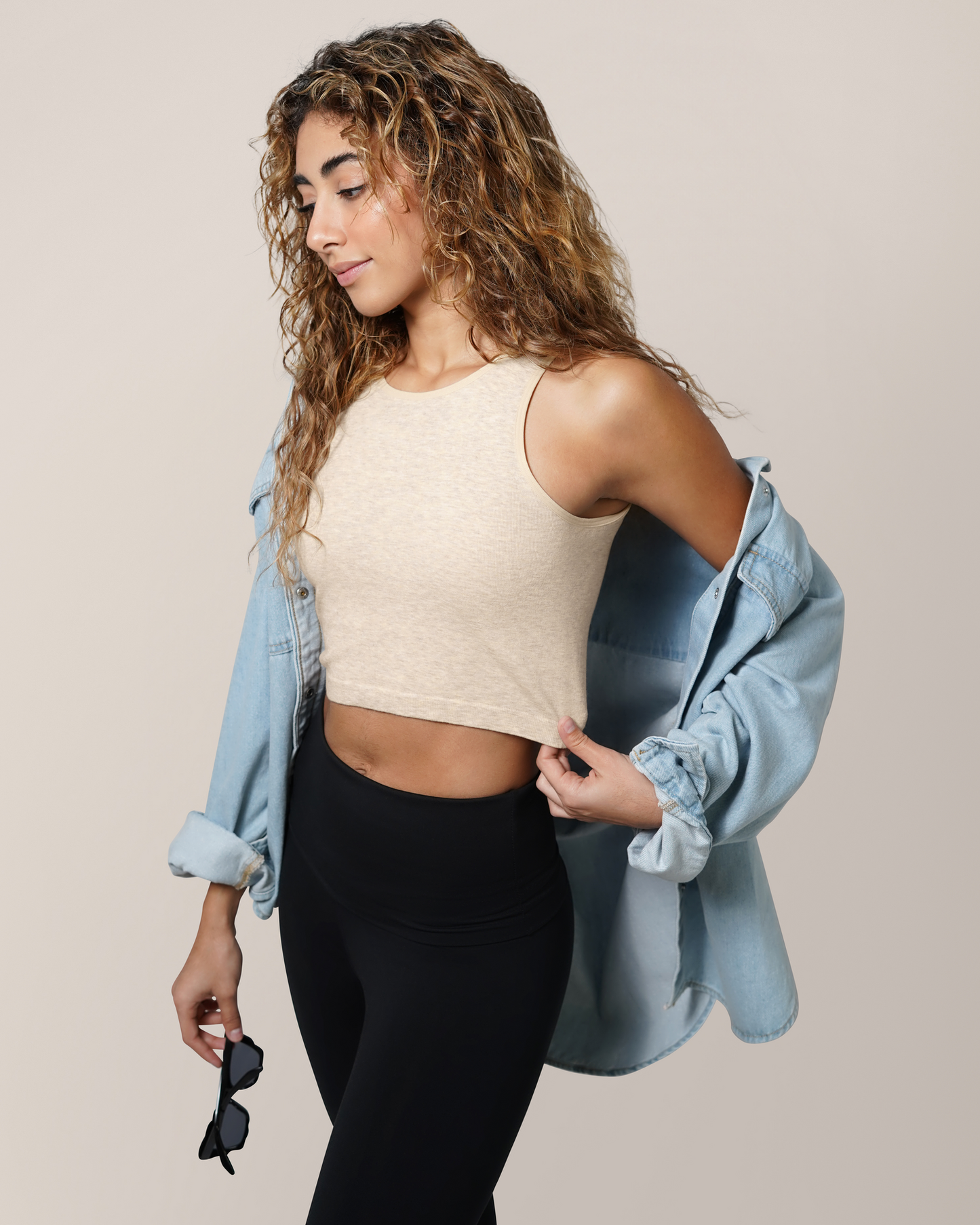 3/4 view of model wearing the Sublime® Bamboo Hands-Free Pumping Longline Bra Top in Oatmeal Heather, paired with open button-down top and the Louisa Legging