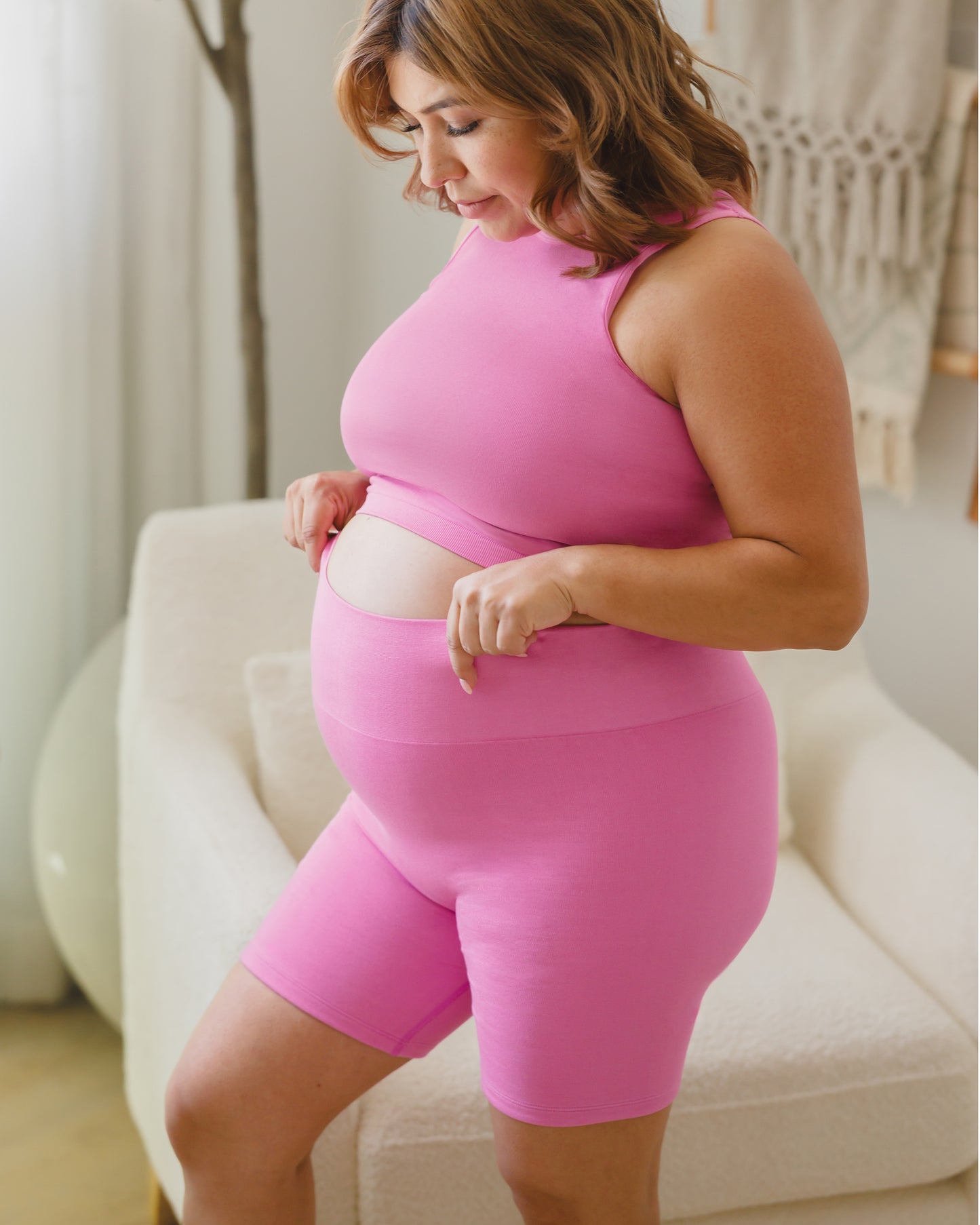 Pregnant model wearing the Sublime® Bamboo Maternity & Postpartum Bike Short in Soft Fuchsia, paired with matching Sublime® Bamboo Maternity & Nursing Longline Bra Top @model_info:Stephani is wearing a Large.