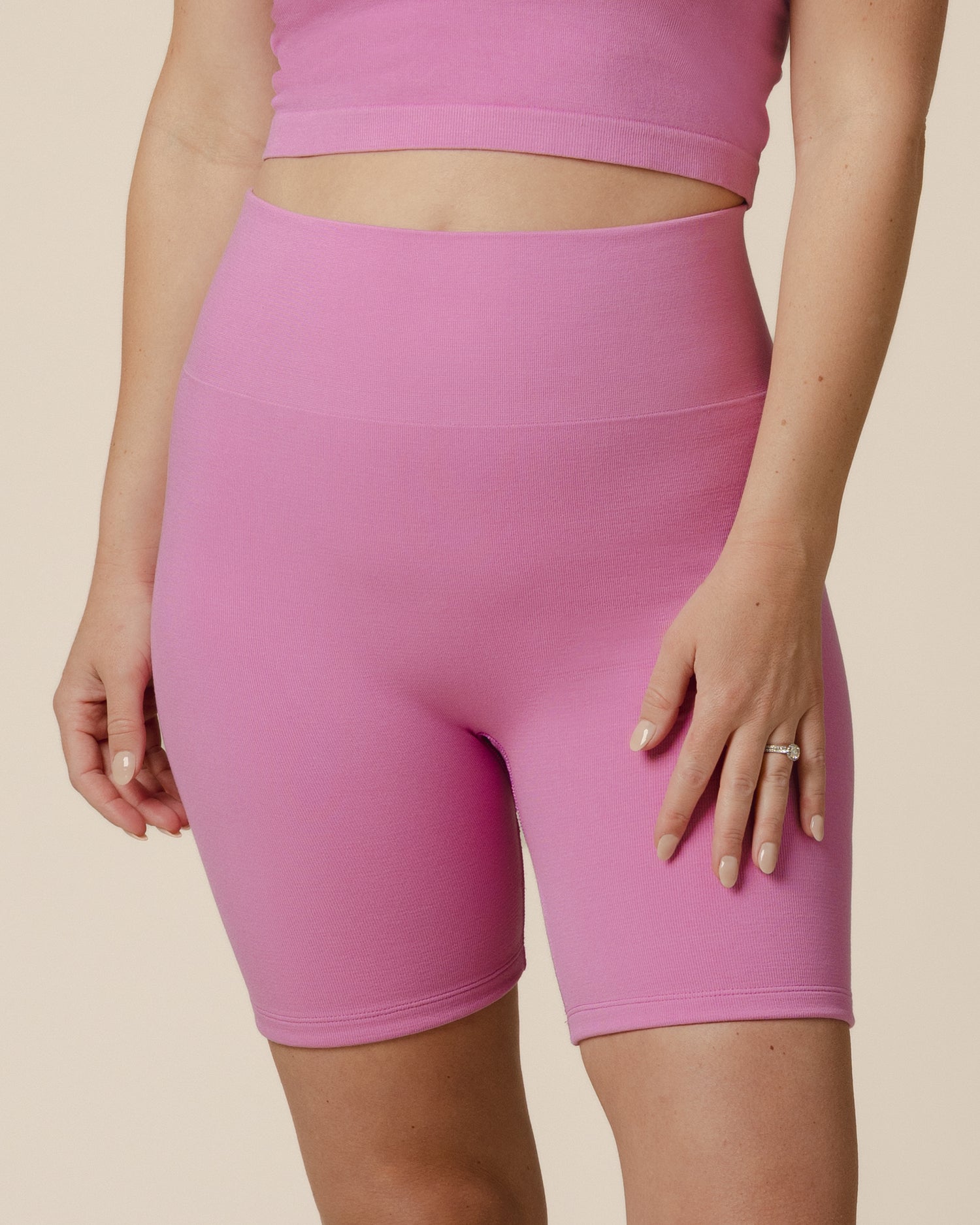 Front cropped in view of model wearing the Sublime® Bamboo Maternity & Postpartum Bike Short in Soft Fuchsia